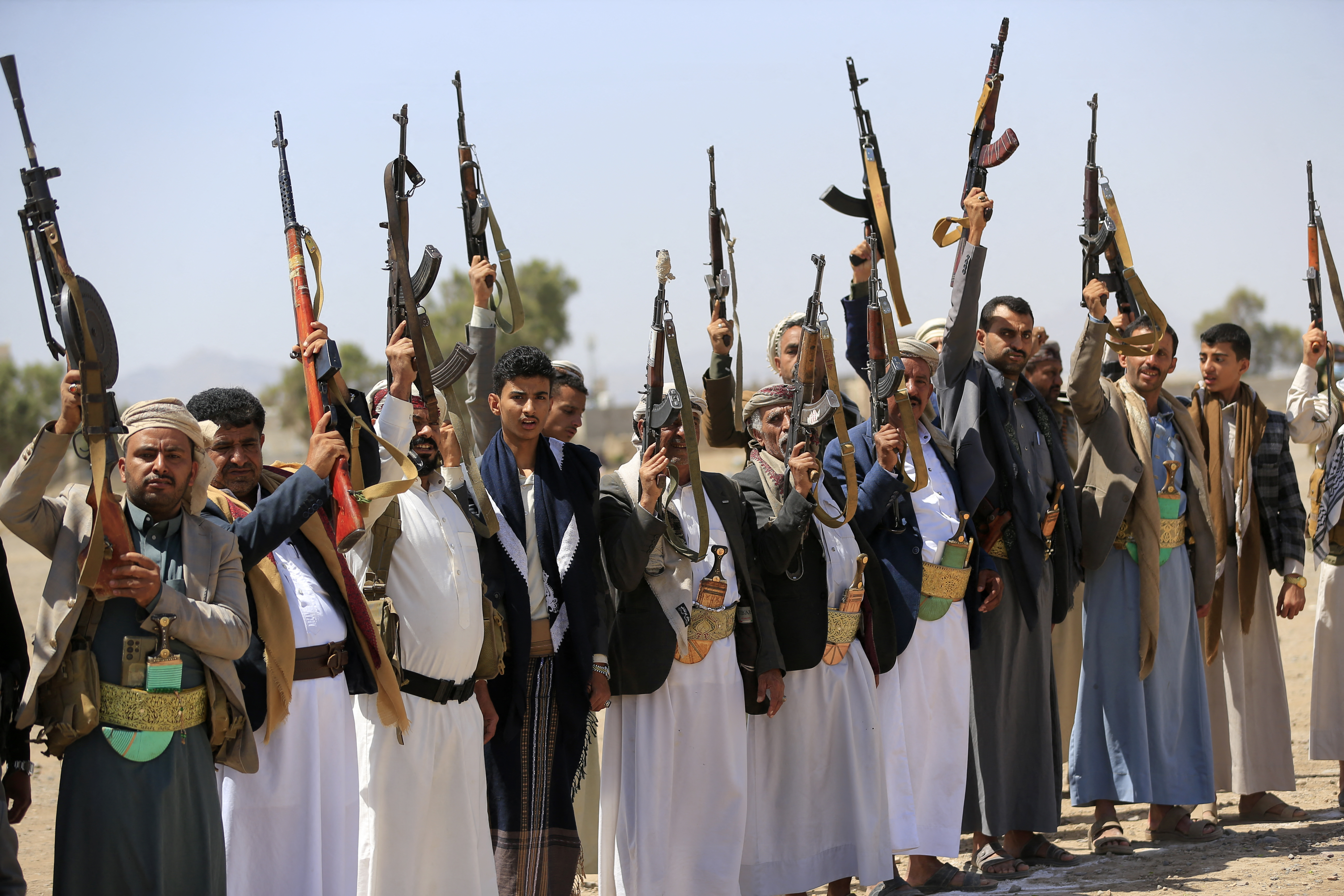 Armed Yemenis brandish their weapons as they rally in solidarity with Lebanon and Iran on the outskirts of the Houthi-controlled capital, Sanaa, on July 2, 2026 [AFP]