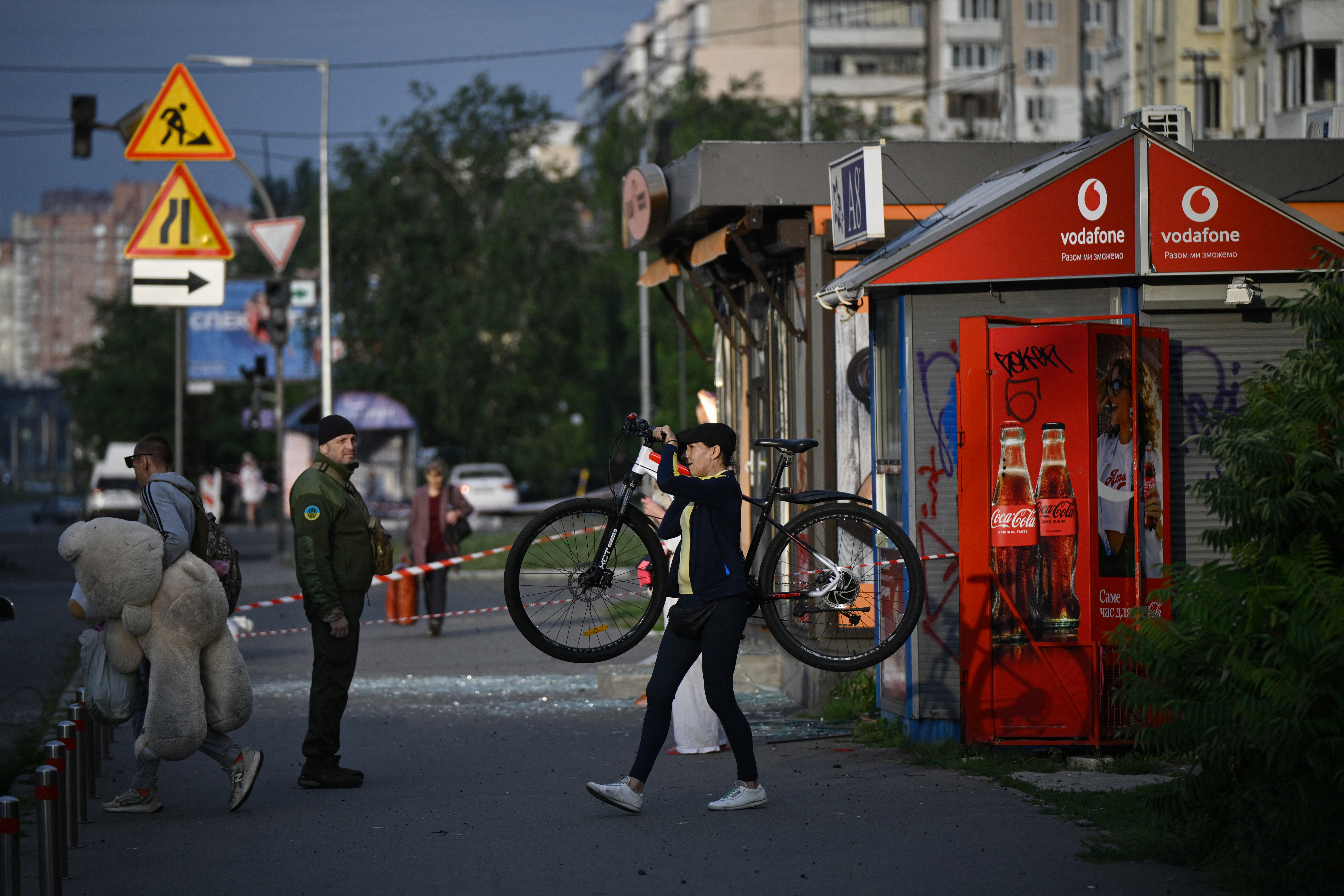 People walk past a bread stall damaged following a Russian missile strike on the Ukrainian capital of Kyiv early on July 11, 2026, amid the Russian invasion in Ukraine.