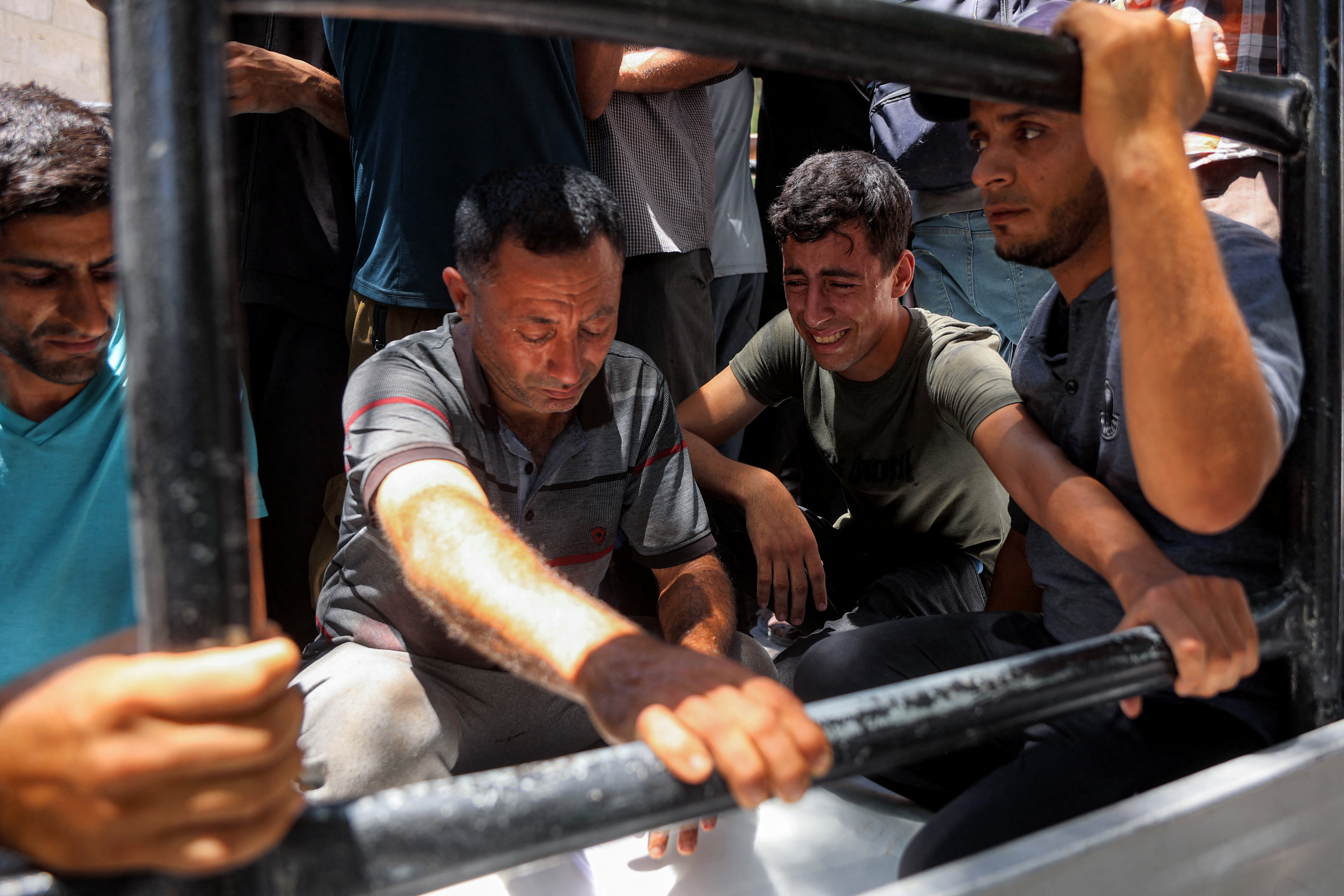 EDITORS NOTE: Graphic content / Men react during the funeral for several victims killed after a police station was was hit by Israeli bombardment in the Jabalia camp for Palestinian refugees in the northern Gaza Strip, in Gaza City on July 14, 2026.