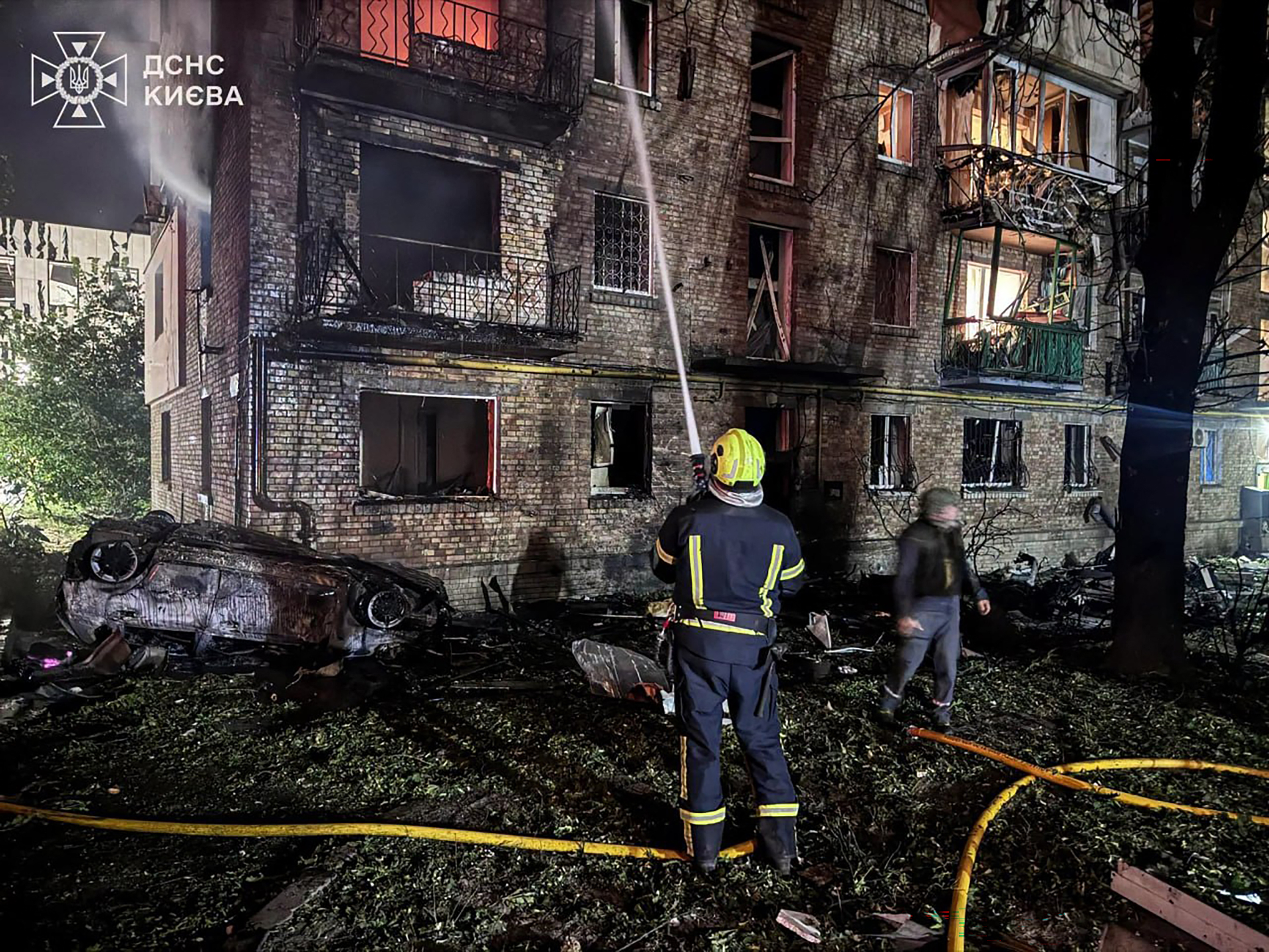 This handout photograph taken and released by Ukrainian State Emergency Service on July 19, 2026 shows rescuers putting out a fire in a residential building following Russian missile strikes on the Ukrainian capital of Kyiv, amid the Russian invasion in Ukraine.