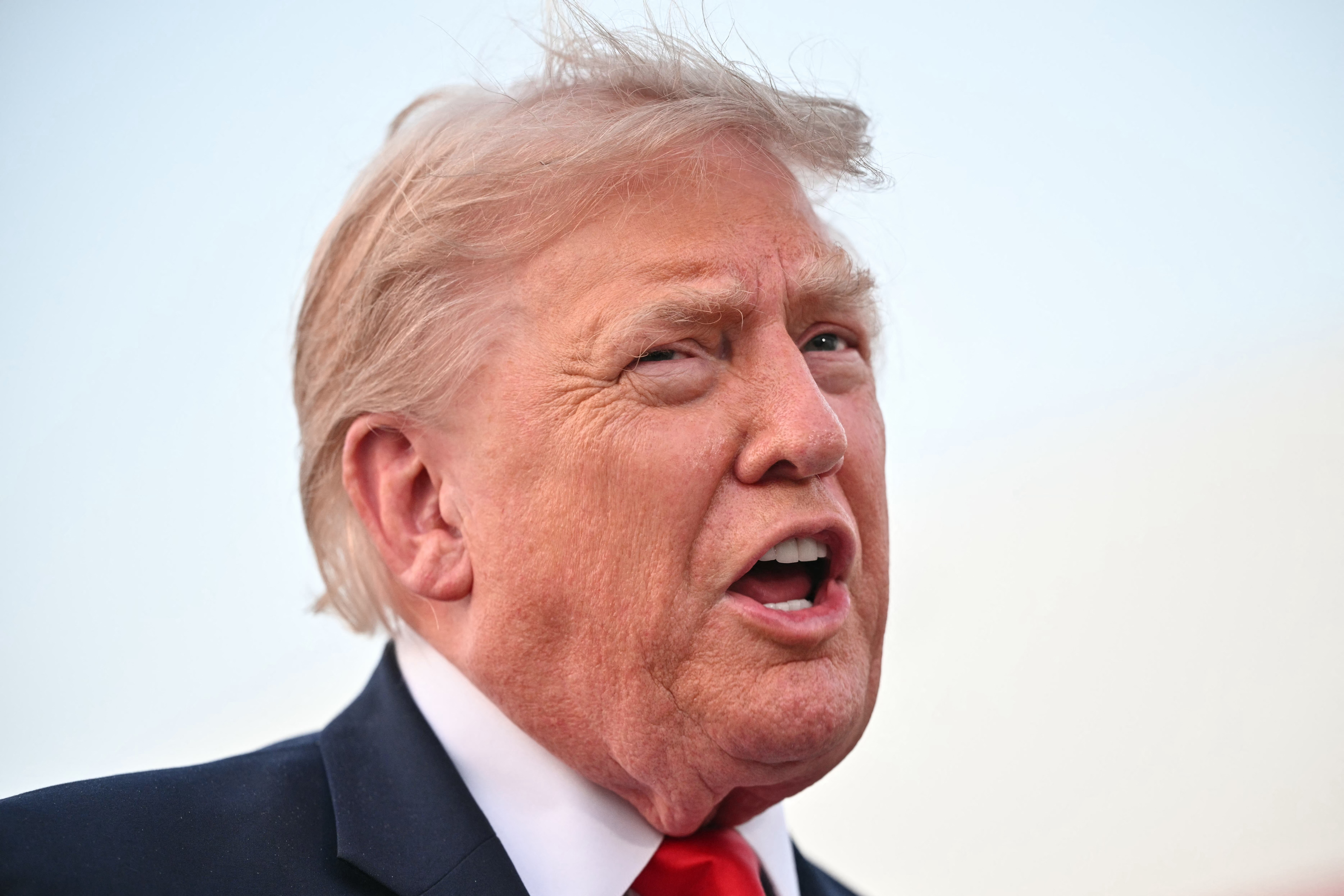 US President Donald Trump speaks to reporters after stepping off Air Force One upon returning to Joint Base Andrews in Maryland on July 19, 2026.