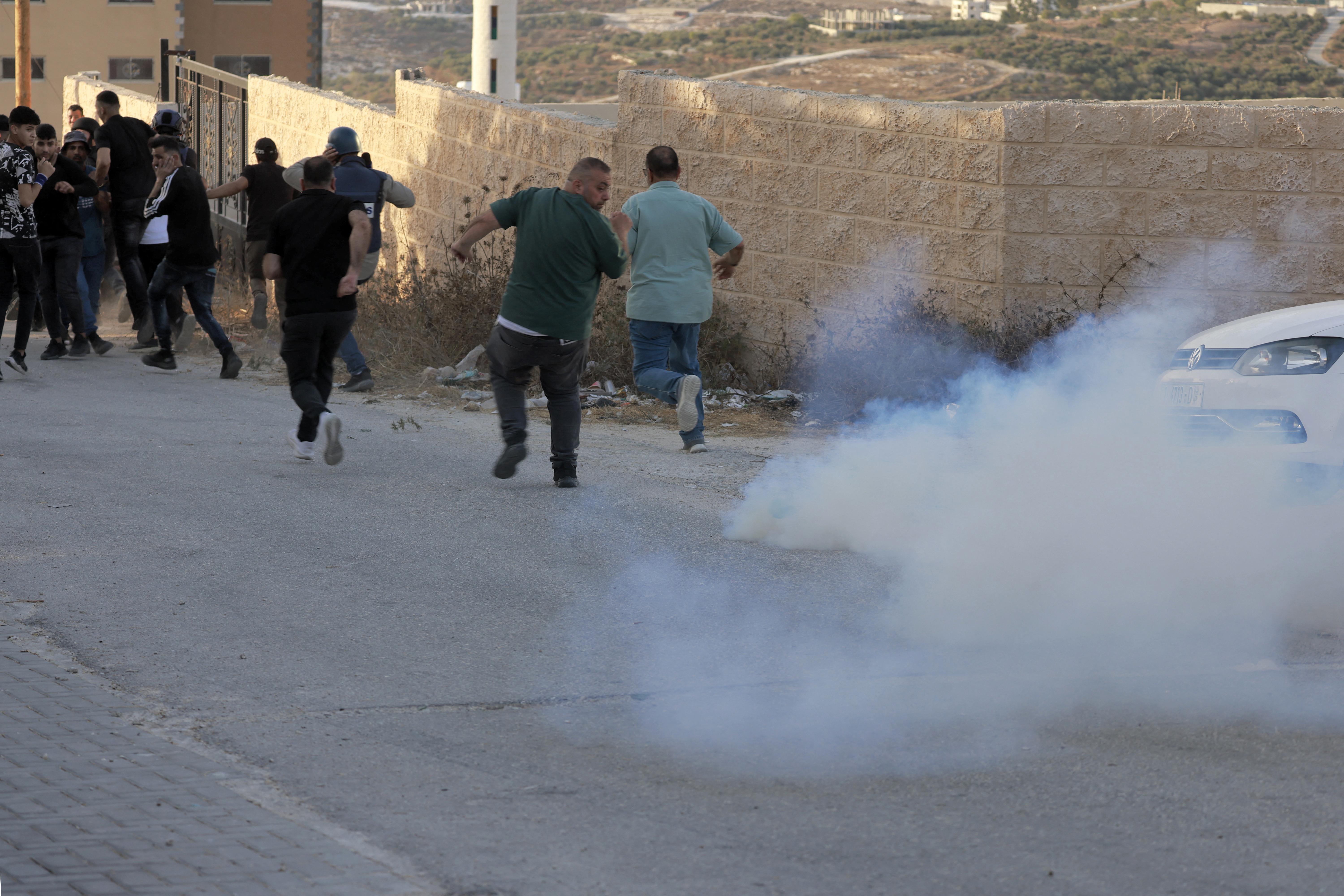 Israeli forces use tear gas during clashes between settlers and Palestinians from the village of Tal in the occupied West Bank