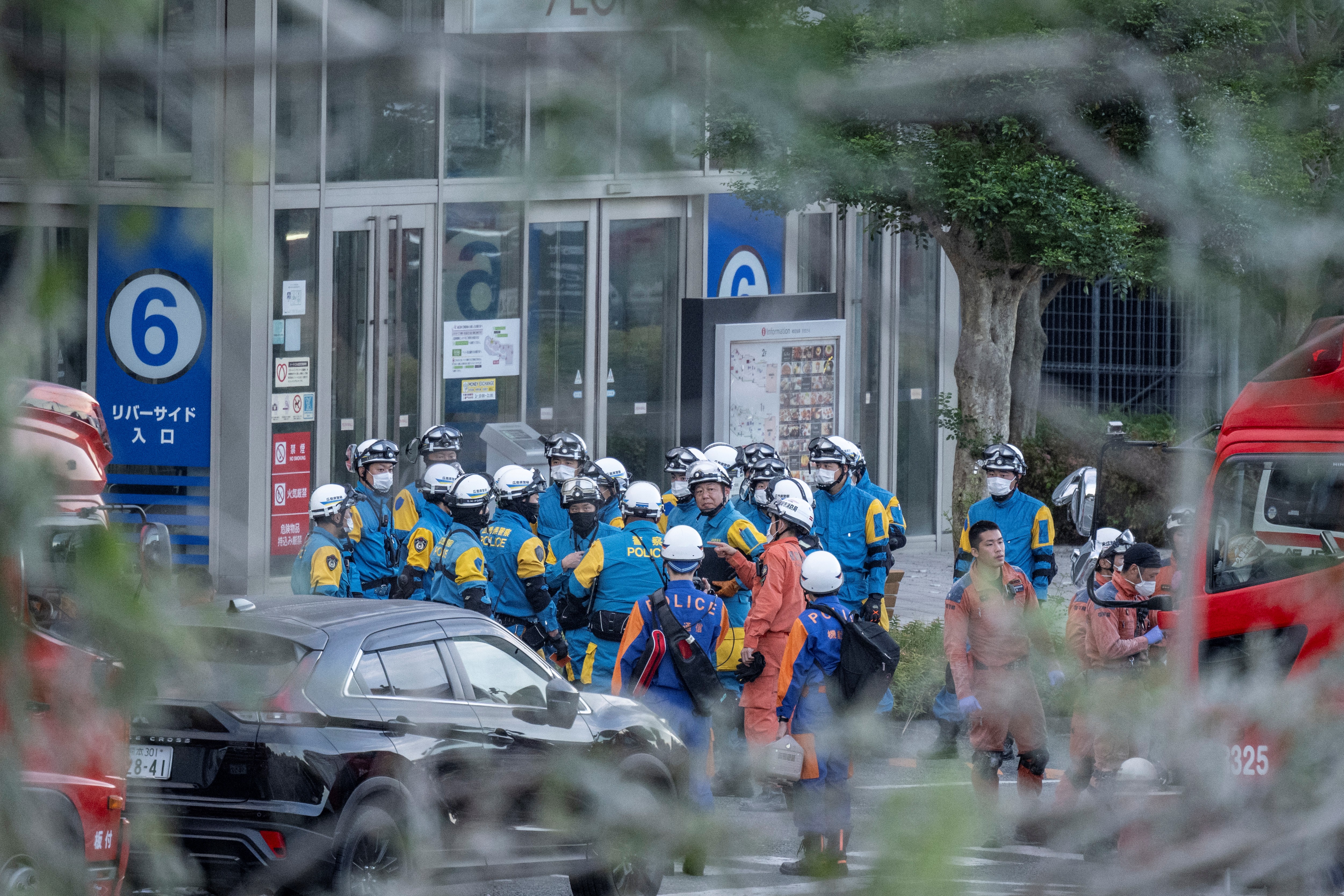 Emergency workers gather outside the Aeon Mall Kumamoto in Kashima, Kumamoto Prefecture, on July 29, 2026 after an earthquake struck the area.