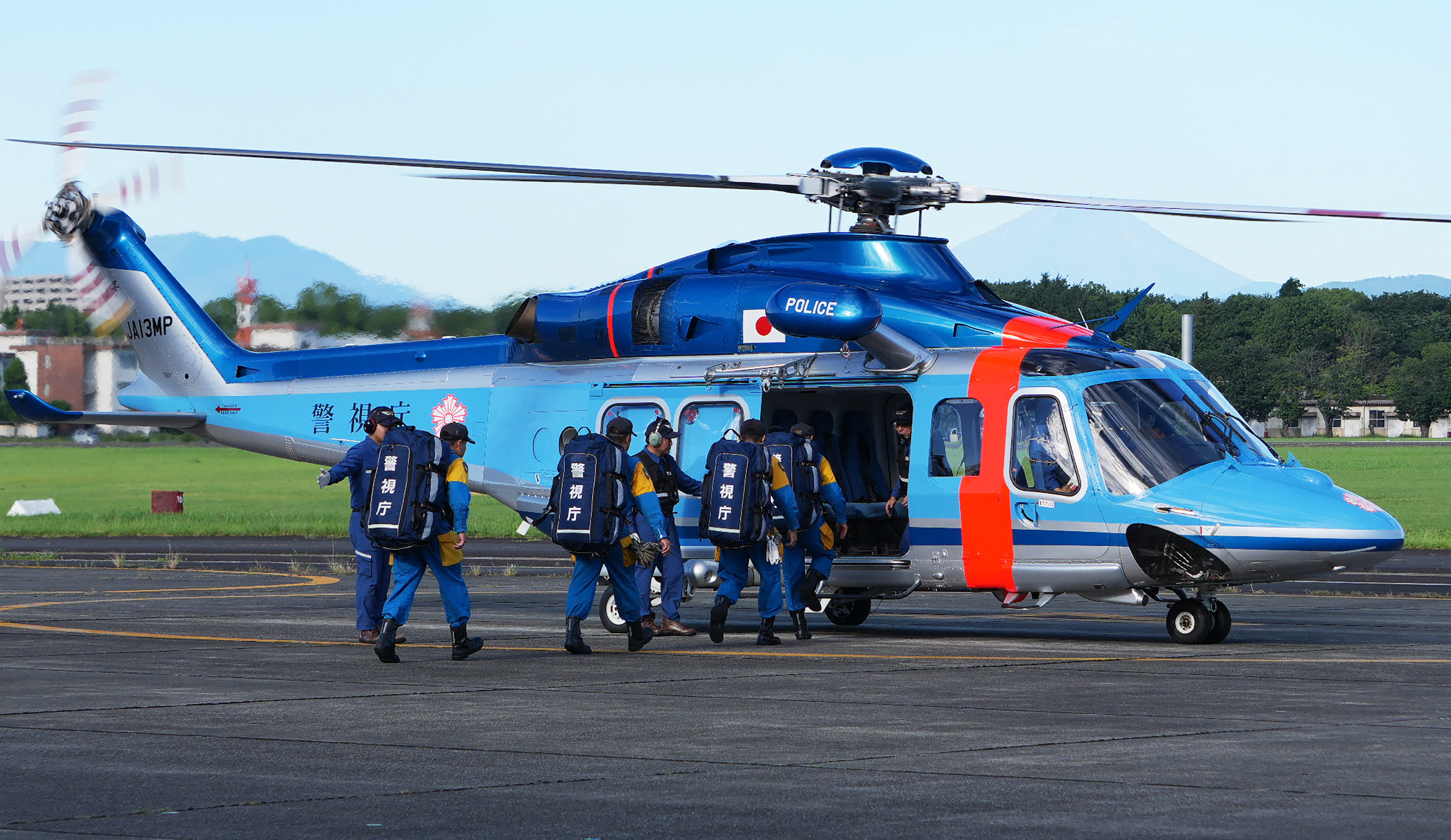 Members of the Tokyo Metropolitan Police Department's Special Rescue Team and Air Unit board a helicopter to head out to Kumamoto Prefecture to search for missing persons following the 7.1-magnitude earthquake, in Tokyo on July 29, 2026.