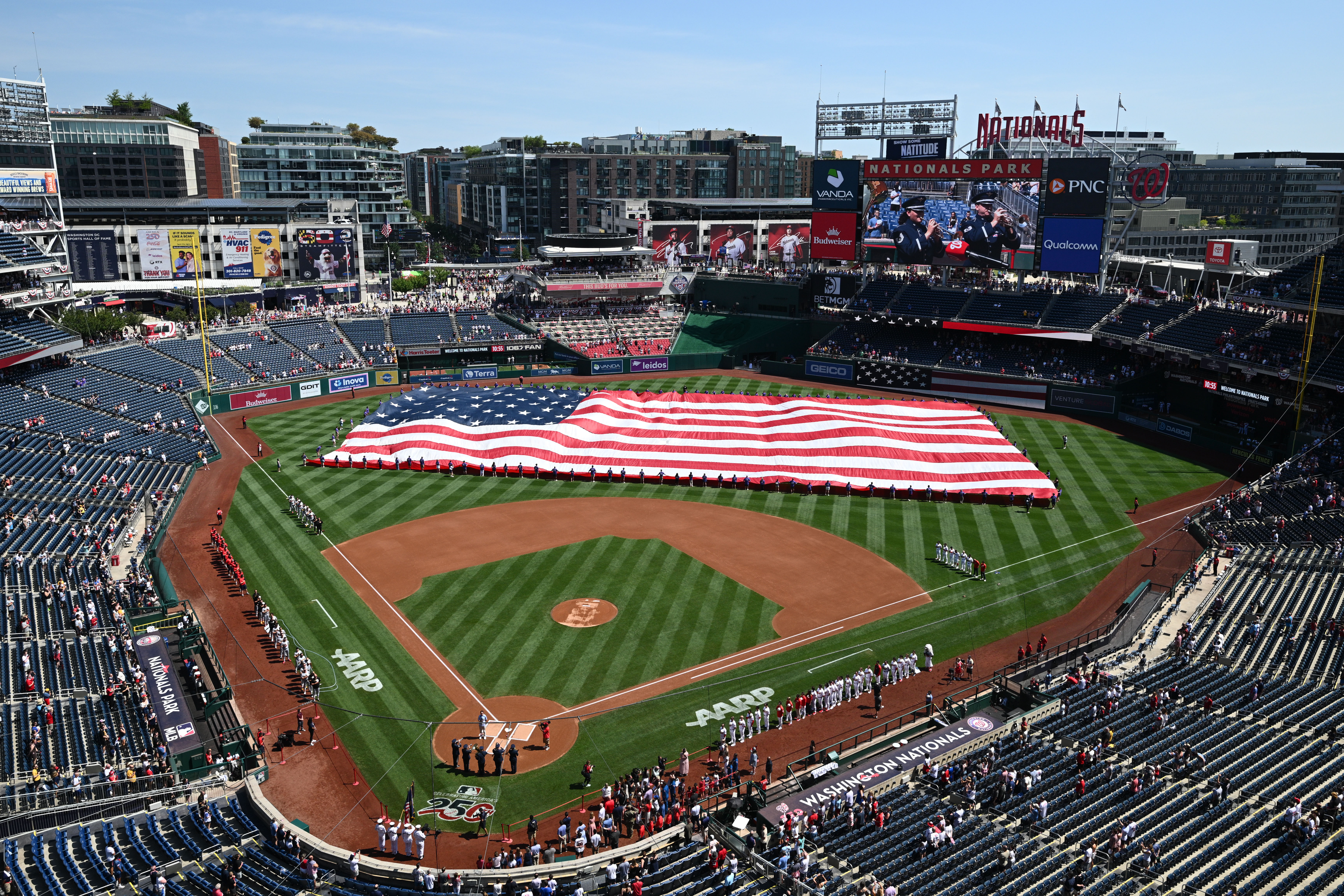 A giant American flag is displayed on the field before a baseball game between the Washington Nationals and the Pittsburgh Pirates, Saturday, July 4, 2026, in Washington. (AP Photo/Nick Wass)