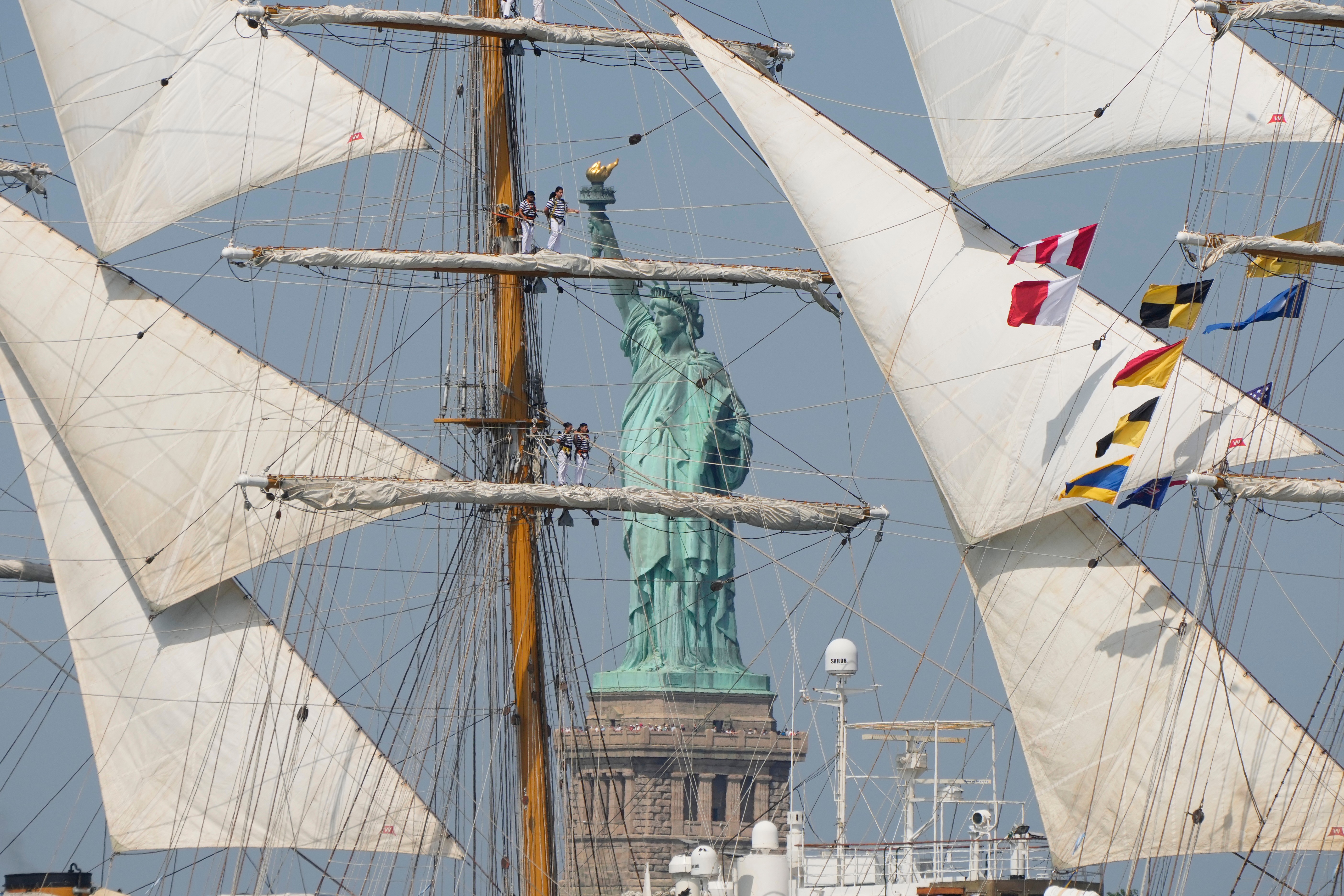 The Statue of Liberty is framed by Argentina's Ara Libertad in the New York harbor during the International Parade of Sail, part of Sail250, a gathering of tall ships and military ships, Saturday, July 4, 2026, in New York. (AP Photo/Yuki Iwamura)