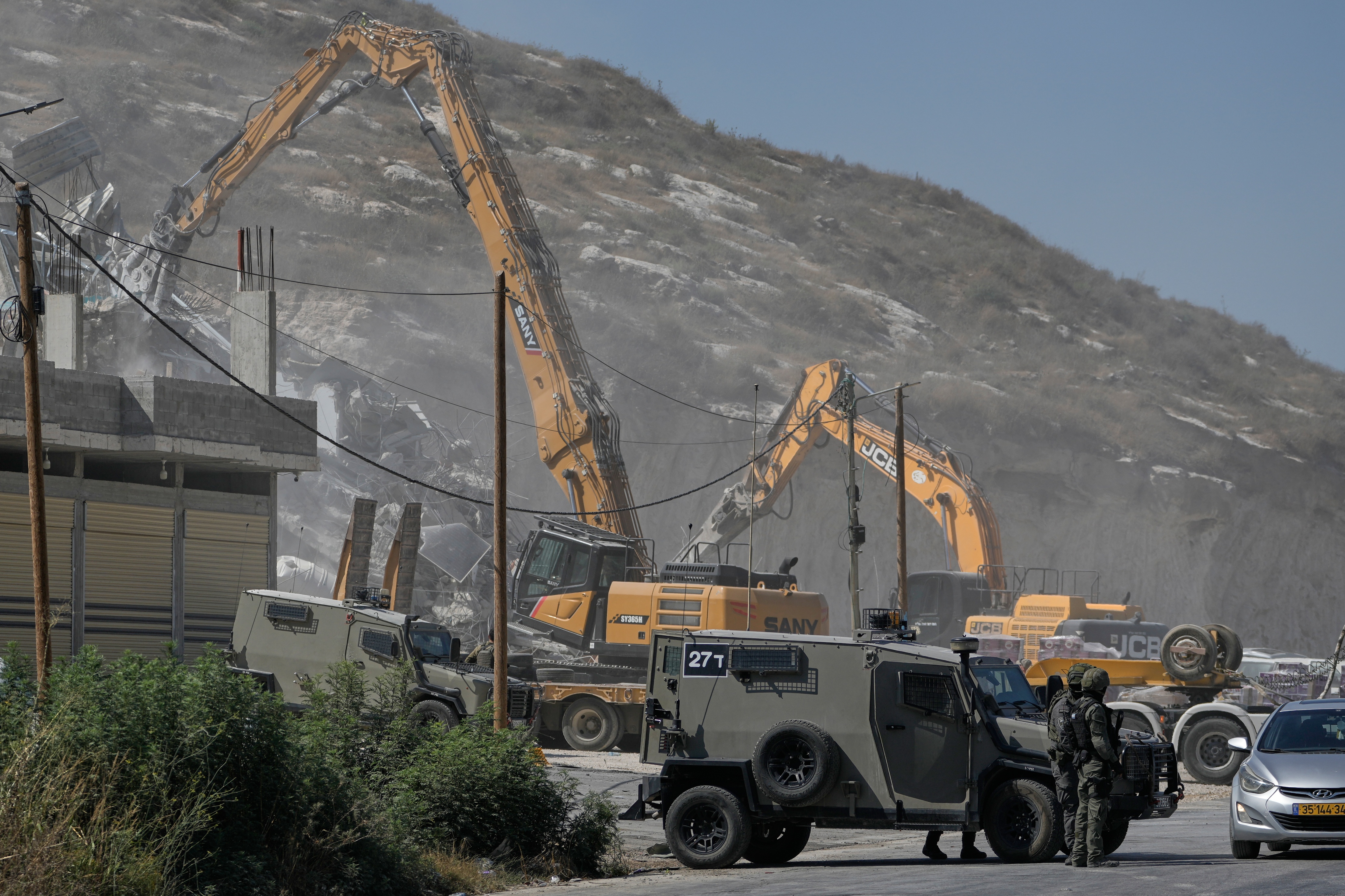 Israeli army bulldozers demolish a Palestinian building in the West Bank village of Anza, Monday, July 27, 2026. [File: Majdi Mohammed/AP]