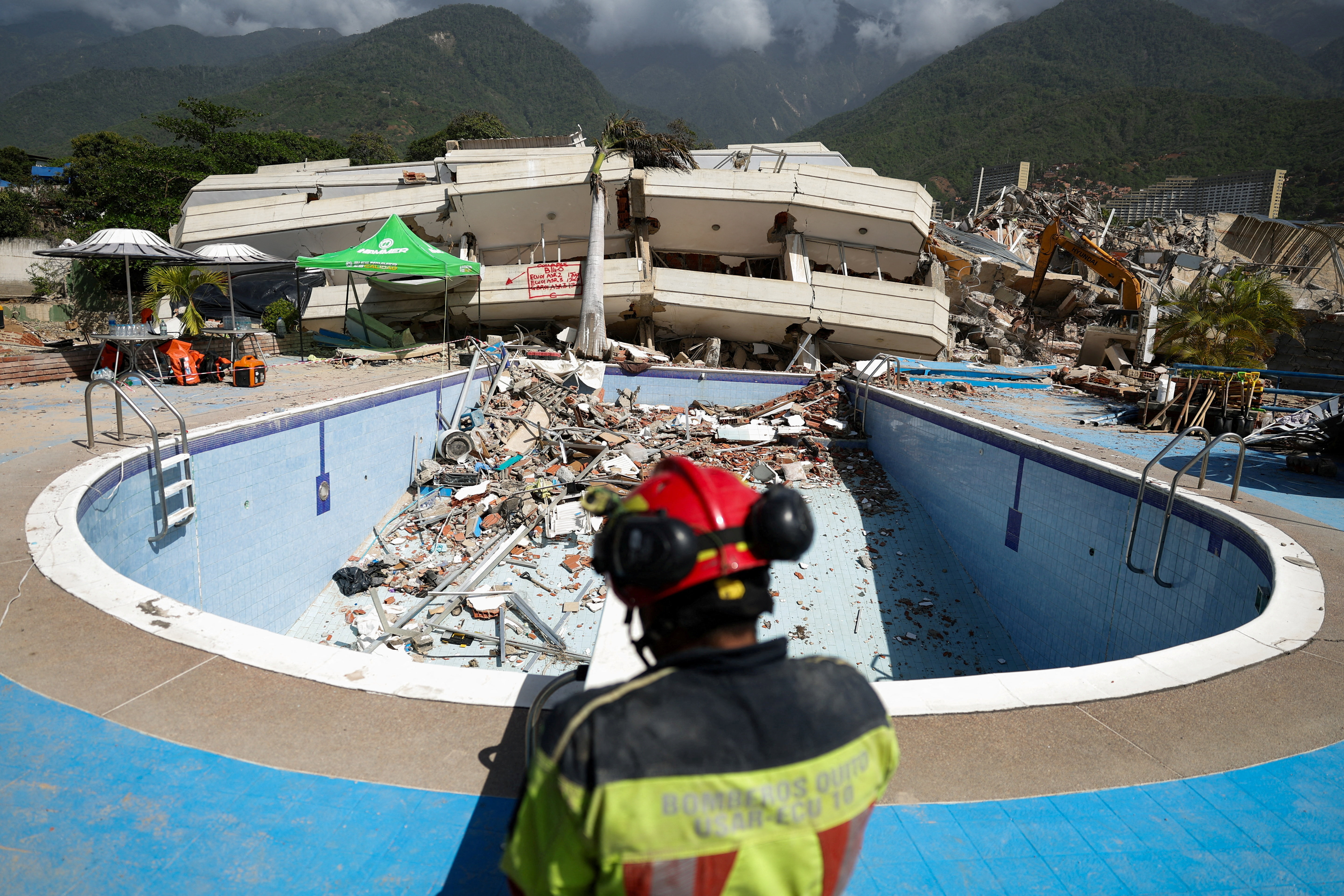 A firefighter works at the site of a collapsed building, in the aftermath of earthquakes, in La Guaira, Venezuela, July 1, 2026. REUTERS/Ricardo Arduengo TPX IMAGES OF THE DAY