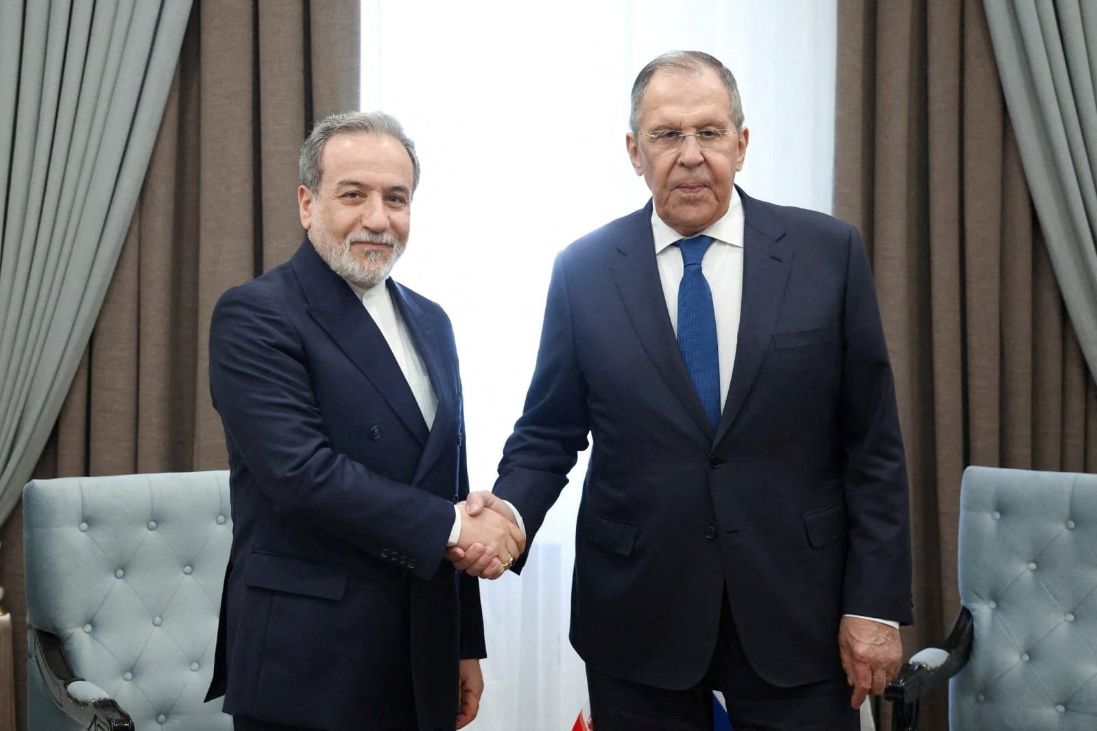 Russian Foreign Minister Sergei Lavrov shakes hands with Iranian Foreign Minister Abbas Araqchi during their talks on the sidelines of the Shanghai Cooperation Organisation (SCO) Council of Foreign Ministers meeting in Cholpon-Ata, Kyrgyzstan July 24, 2026. 