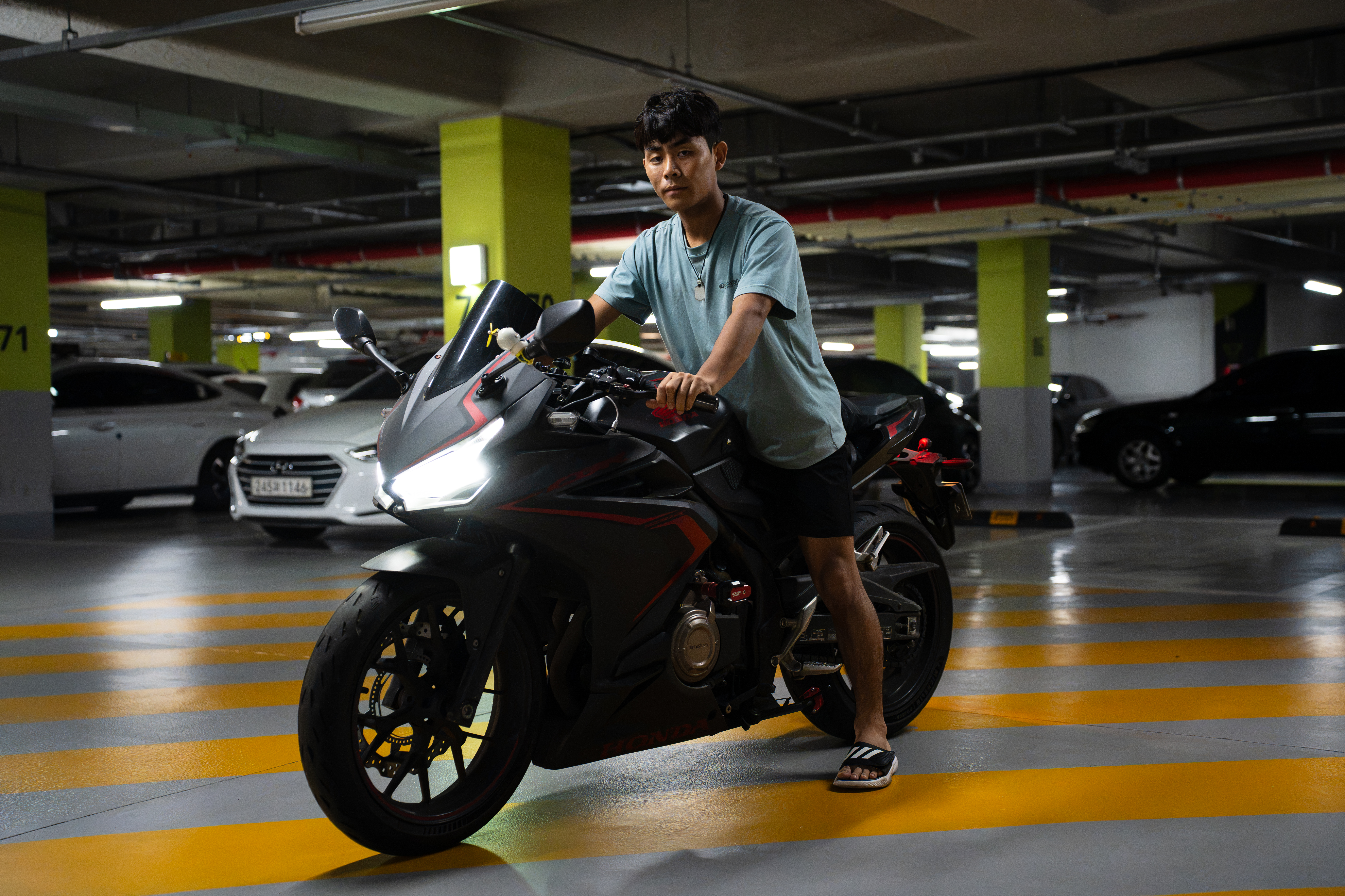 Kim Kangwoo with his 500cc Honda in the parking garage of his home outside Seoul [Ifang Bremer/Al Jazeera]