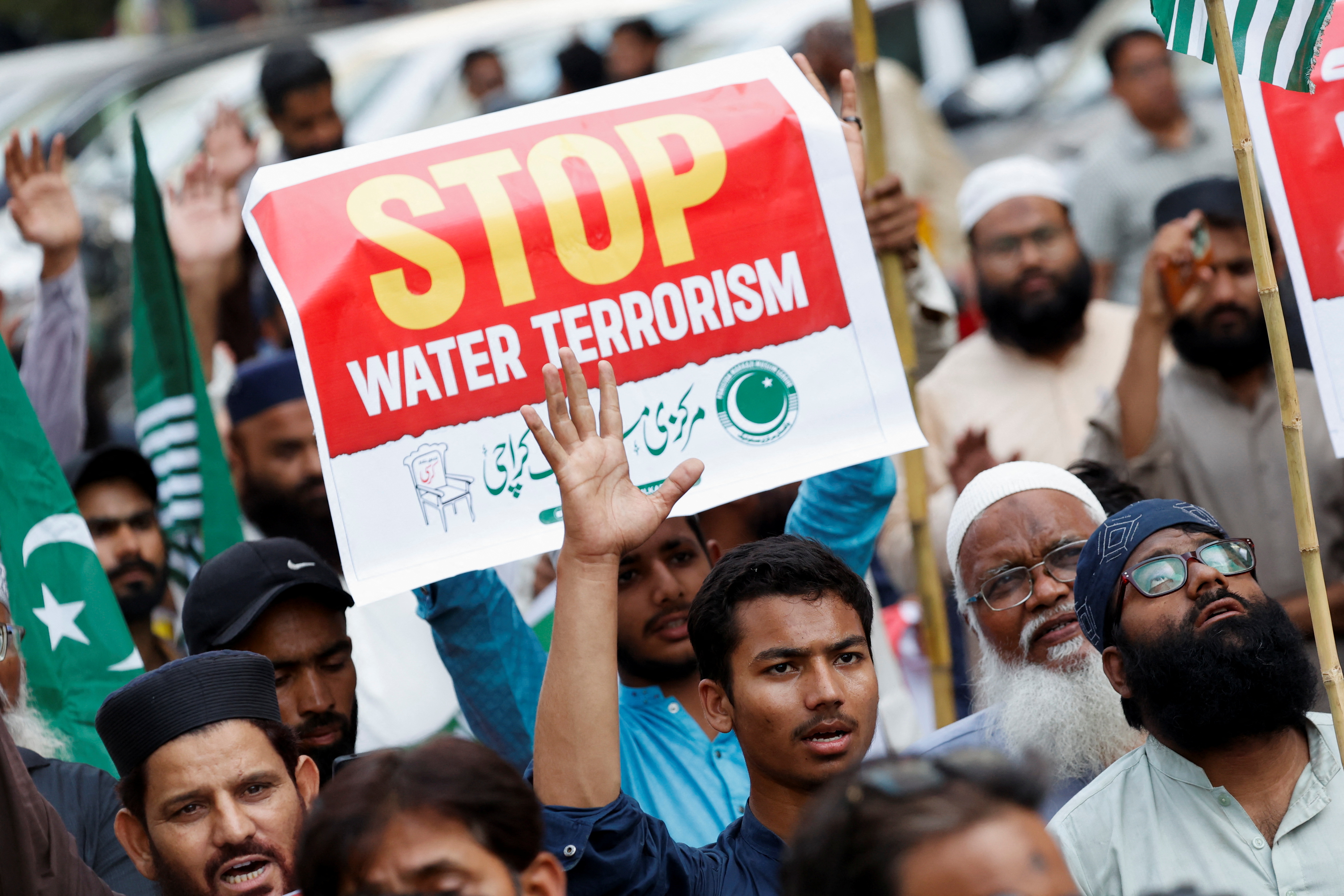 Protestors carry flags and banners during a protest against the suspension of the Indus Waters Treaty by India, in Karachi, Pakistan [File: Akhtar Soomro/Reuters]