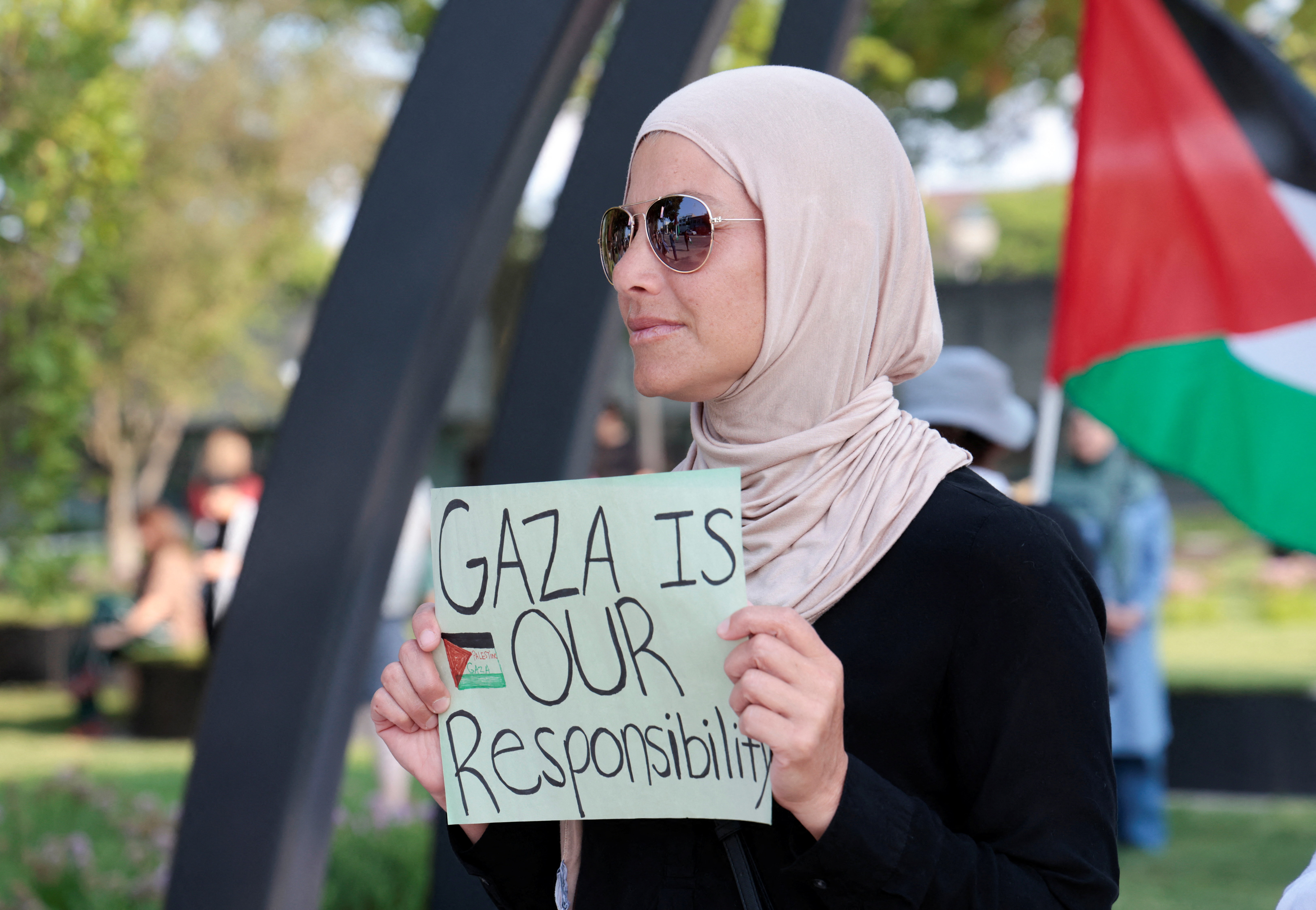 Woman holds a sign that reads, 'Gaza is our responsibility'