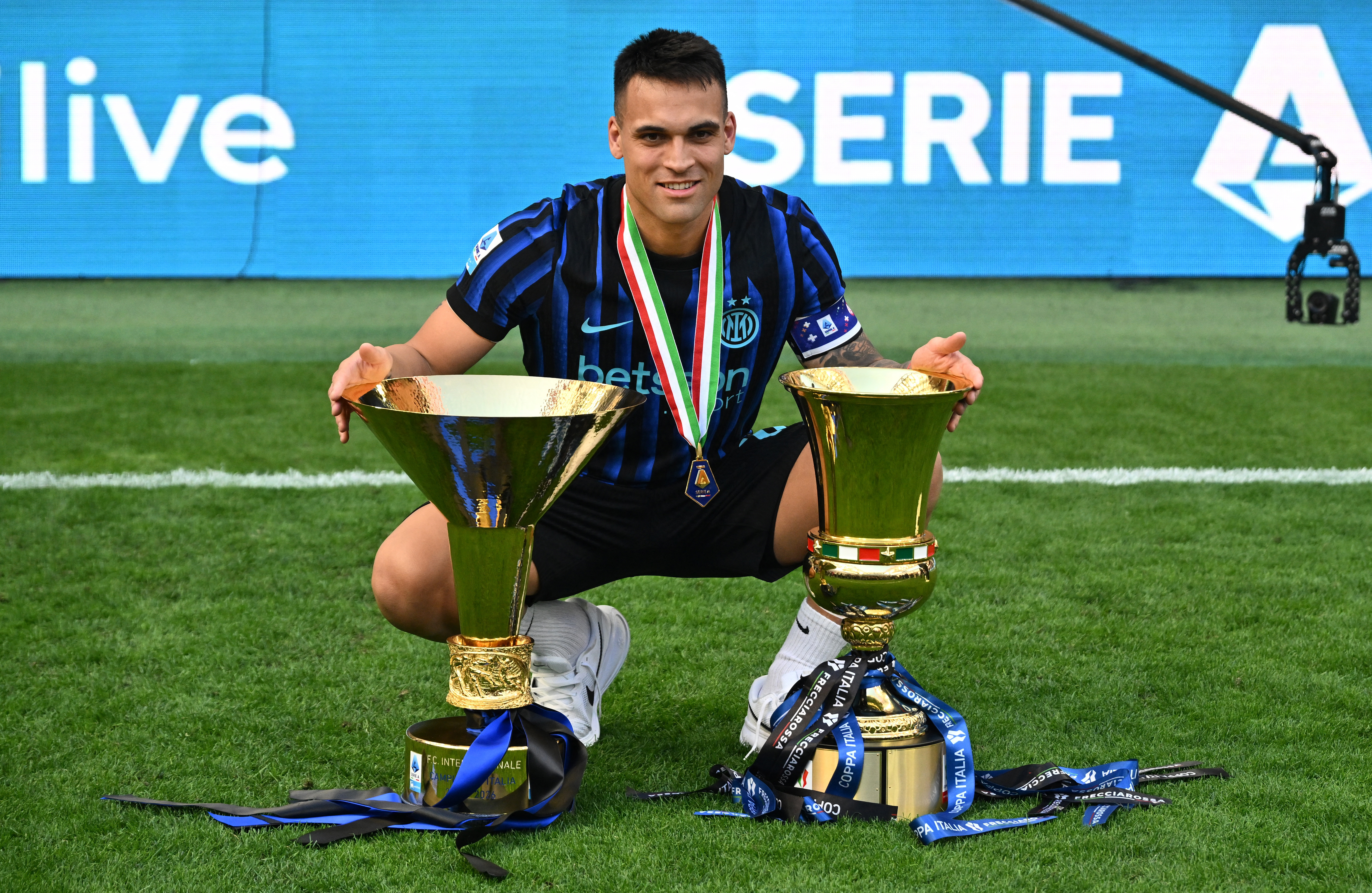 Inter Milan’s Lautaro Martinez celebrates with the Serie A and Coppa Italia trophies [Reuters]
