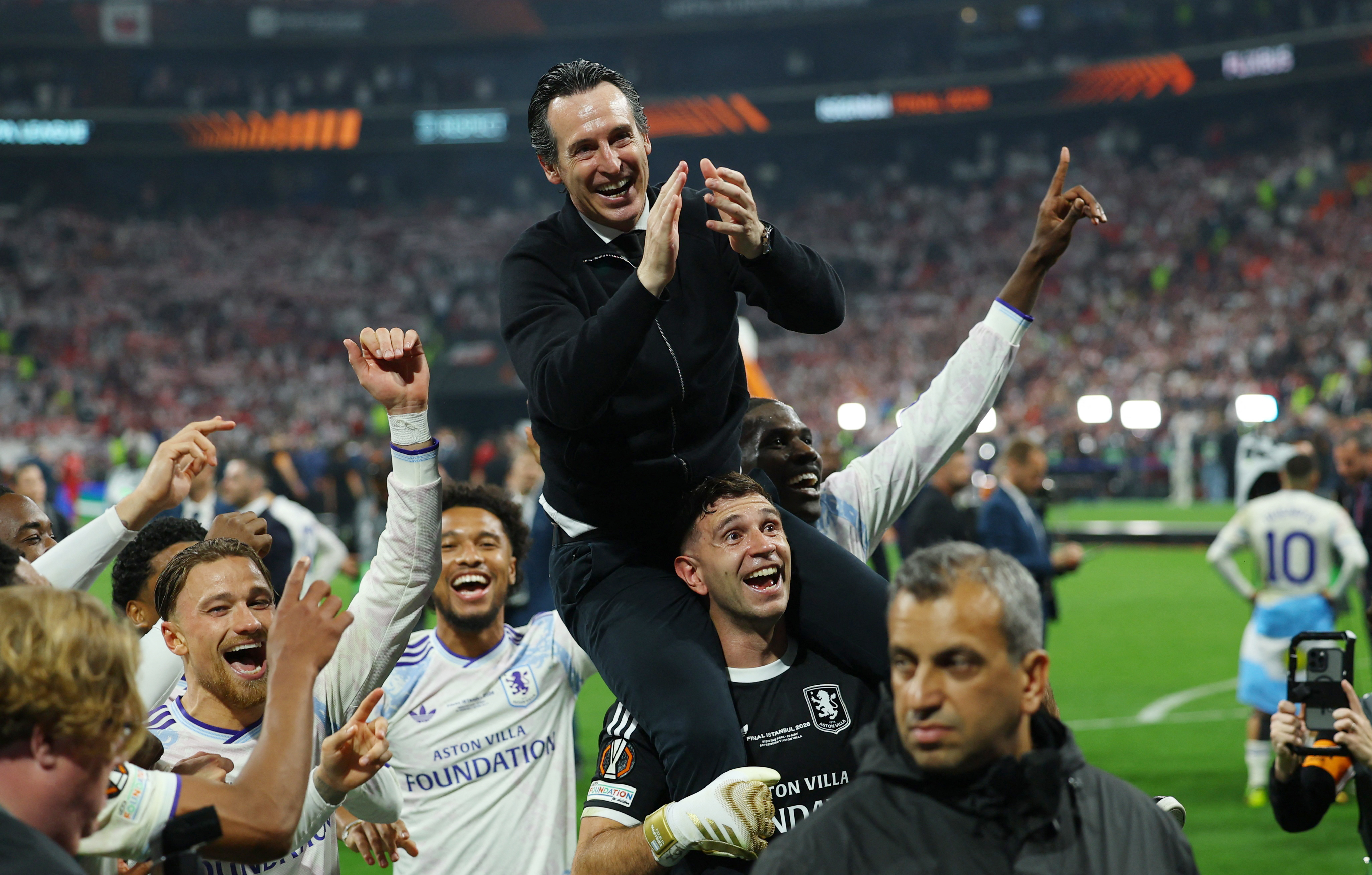 Aston Villa manager Unai Emery, top, and Emiliano Martinez, bottom, celebrate after winning the UEFA Europa League