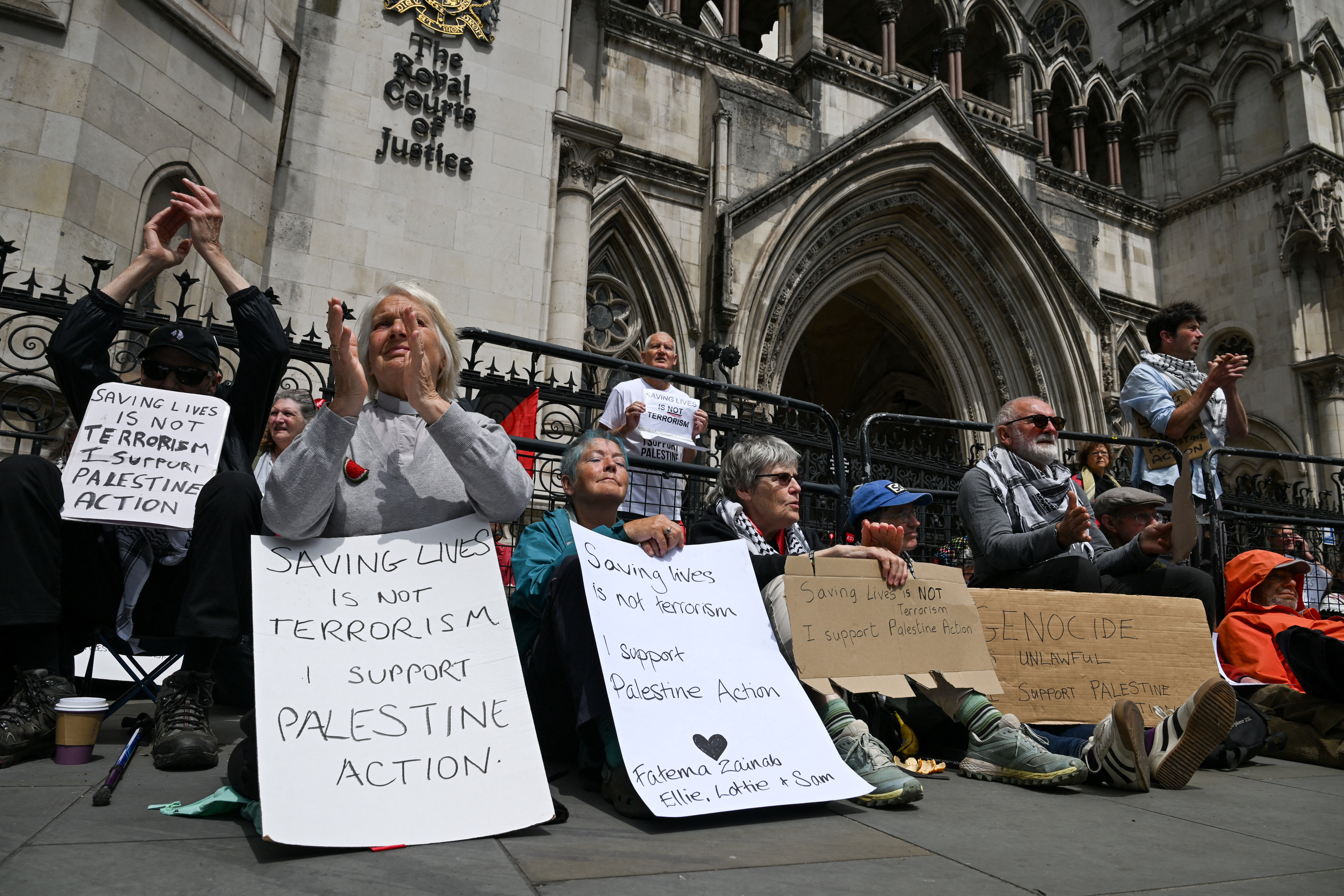 People attend a demonstration opposing the government's decision to ban Palestine Action as a terror organisation, following a Court of Appeal ruling on the lawfulness of proscribing the pro-Palestinian group under terrorism laws, outside the Royal Courts of Justice, in London on June 15, 2026. [Chris J. Ratcliffe/Reuters]
