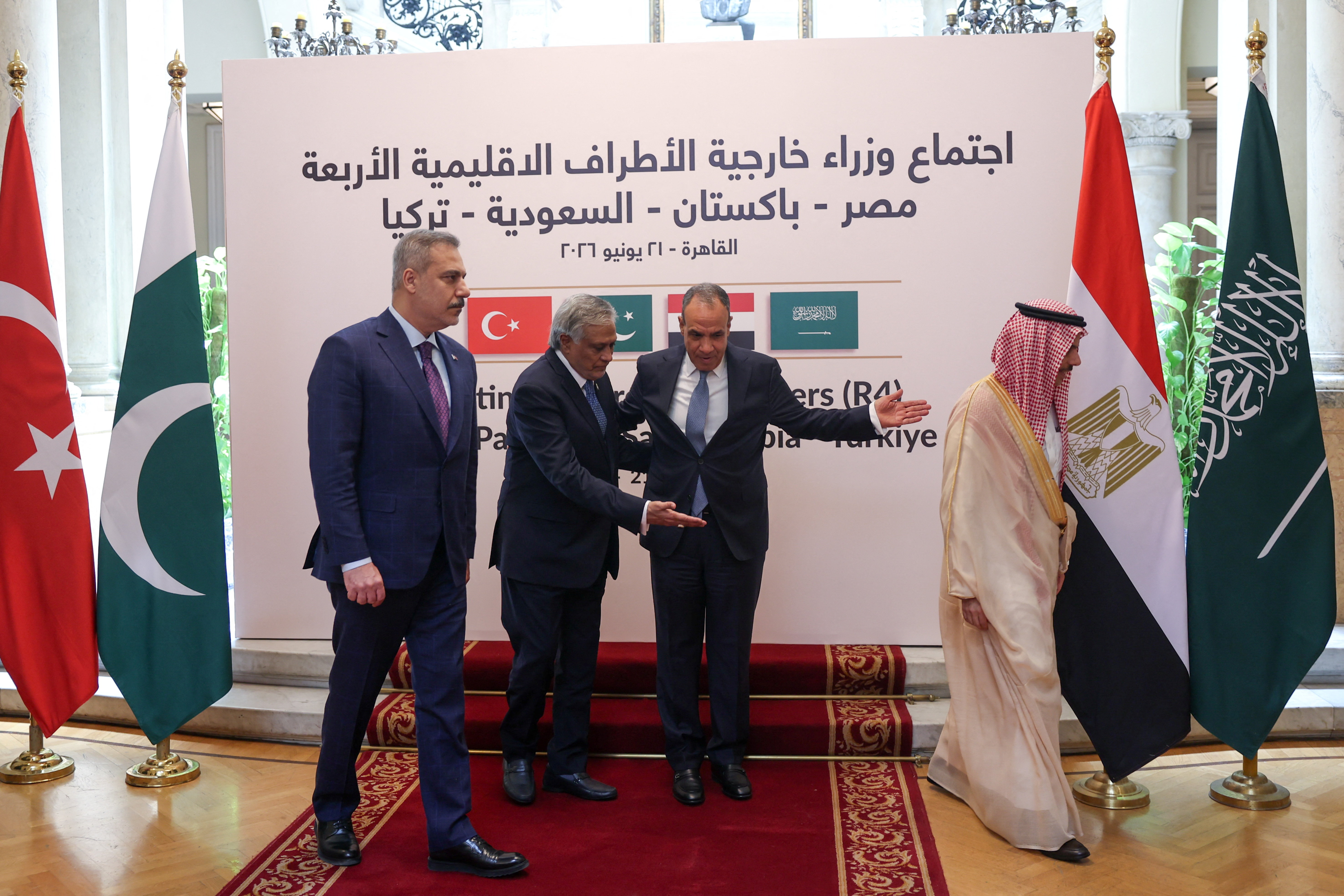 Egyptian Foreign Minister Badr Abdelatty, Turkish Foreign Minister Hakan Fidan, Saudi Foreign Minister Faisal bin Farhan al Saud, and Pakistan's Deputy Prime Minister and Minister for Foreign Affairs Mohammad Ishaq Dar, walk after posing for a photo, as they meet to discuss stability in the region following an interim deal between the U.S. and Iran, at Tahrir Palace in Cairo, Egypt June 21, 2026. REUTERS/Amr Abdallah Dalsh