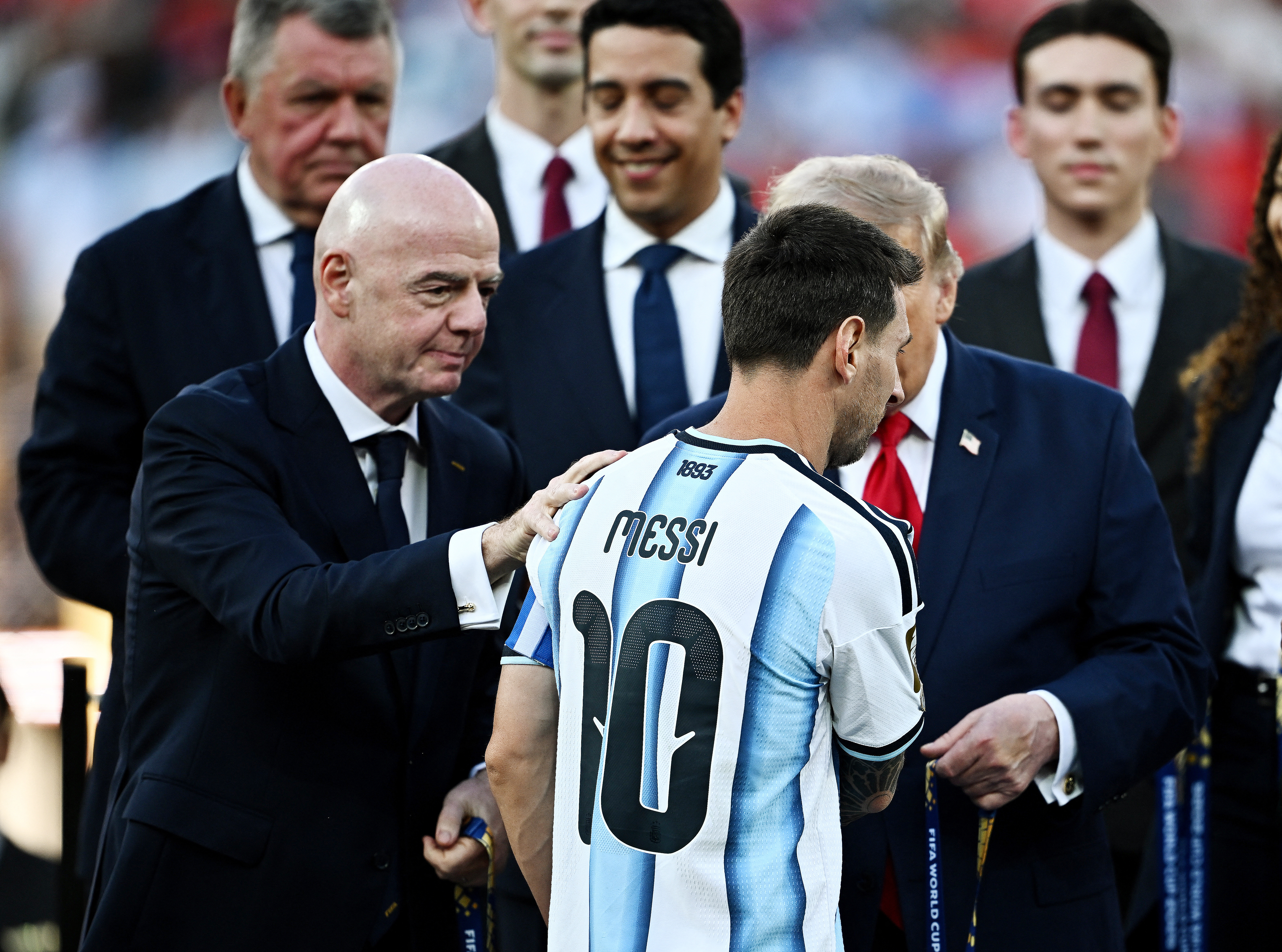 Argentina's Lionel Messi with US President Donald Trump and FIFA President Gianni Infantino as he receives his runners-up medal.