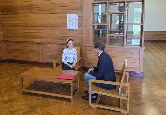 Myanmar's detained former leader Aung San Suu Kyi meets Myanmar's Resident Representative and Head of Delegation for the International Committee of the Red Cross (ICRC) Arnaude de Baecque, in Naypyidaw, Myanmar [Govt Handout via Reuters]