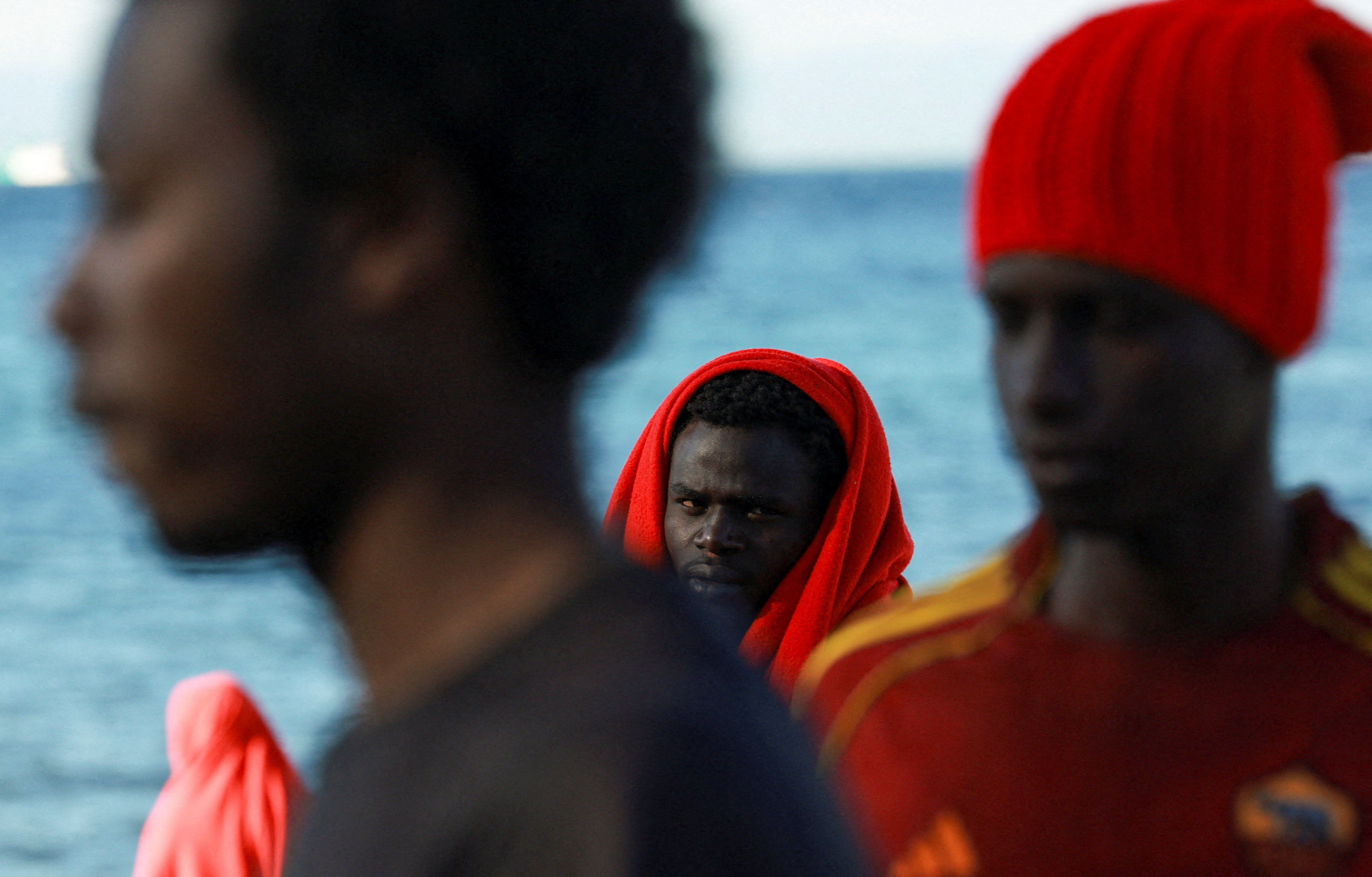 Migrants wait at a beach, following mass crossings of migrants on foot and by sea from Morocco into Spanish territory, in Ceuta, Spain, August 3, 2026. REUTERS/Violeta Santos Moura TPX IMAGES OF THE DAY