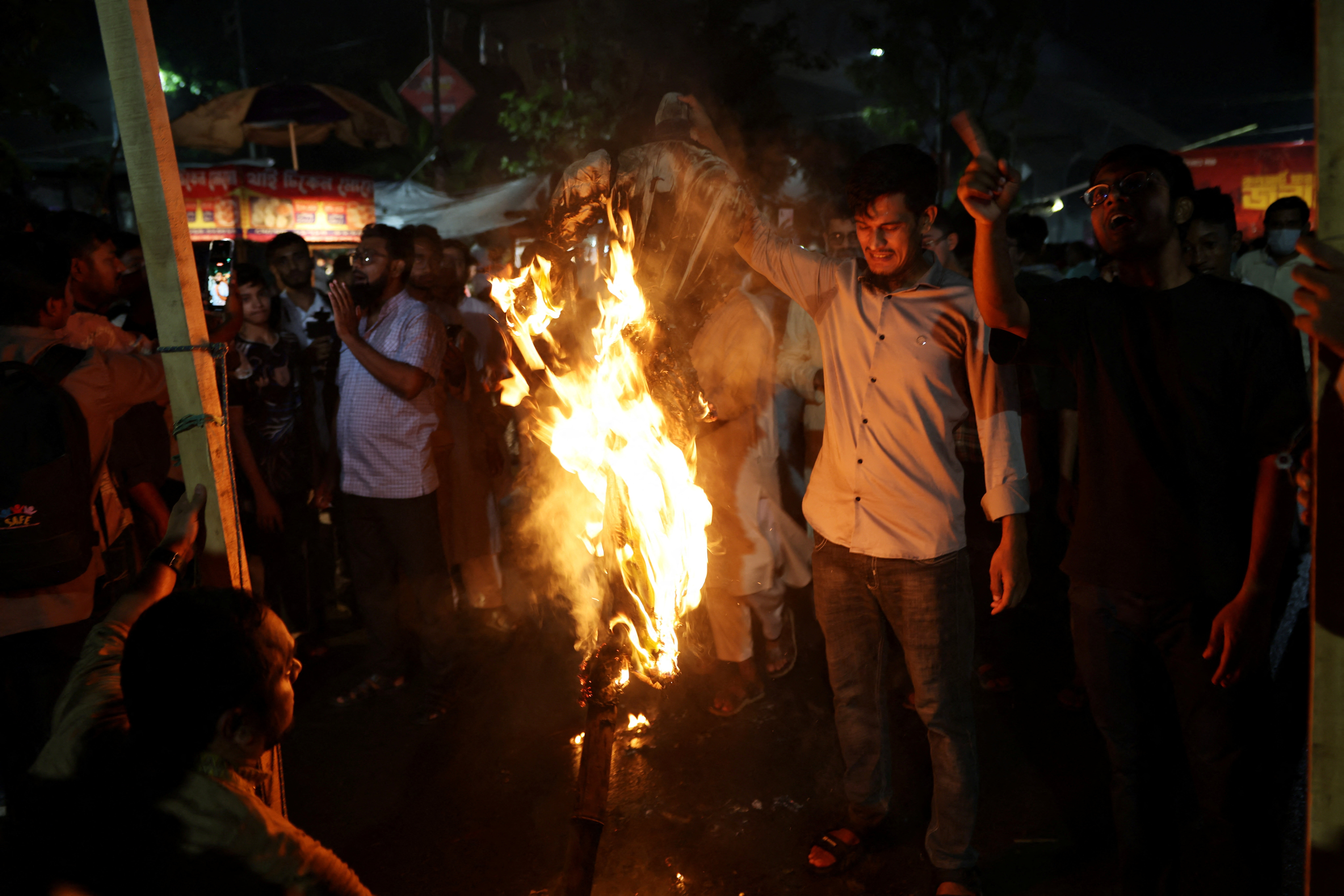 People burn an effigy of ousted Bangladeshi Prime Minister Sheikh Hasina.