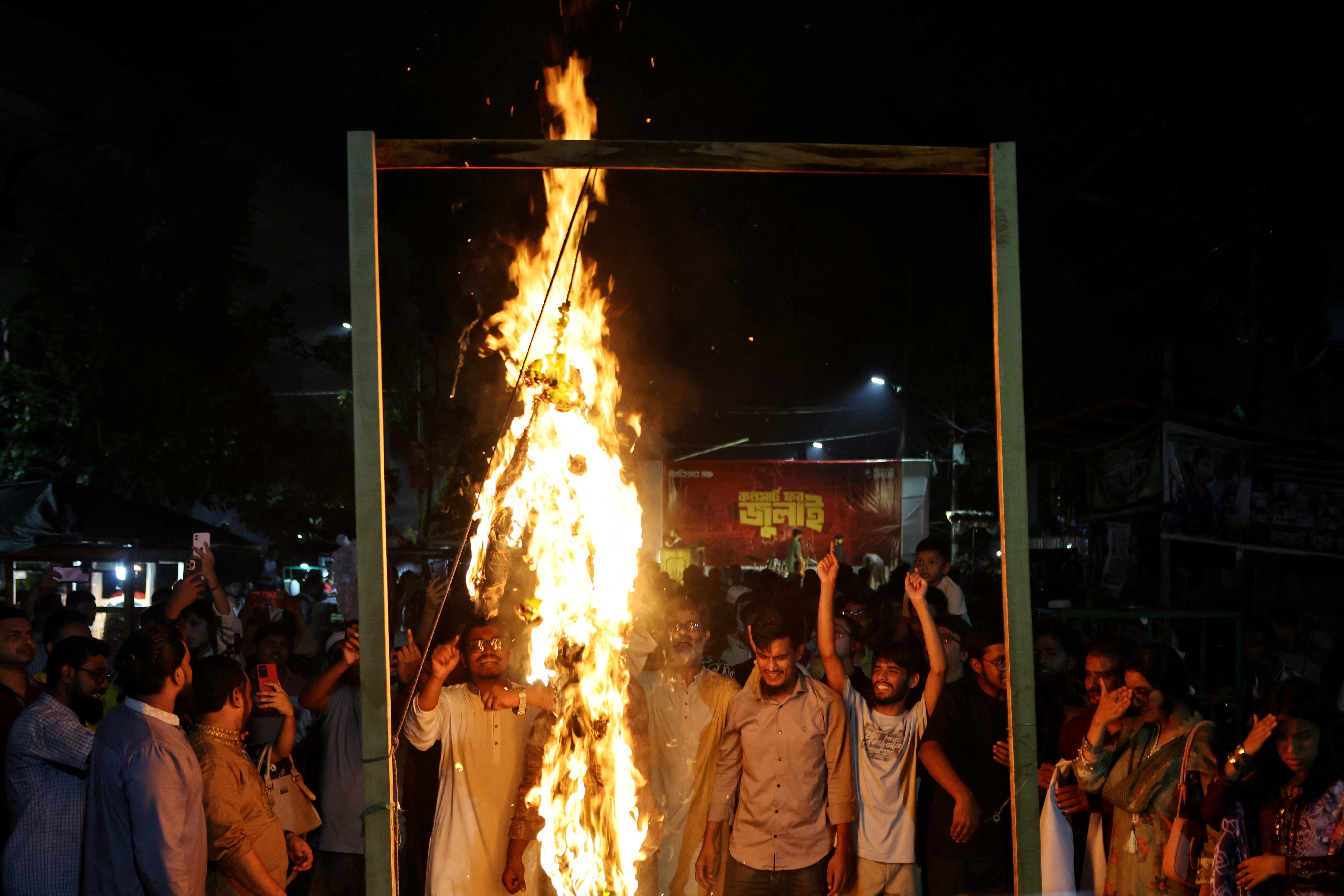People hang and burn an effigy of Hasina during her address at New Delhi’s Foreign Correspondents’ Club of South Asia, in Dhaka, Bangladesh