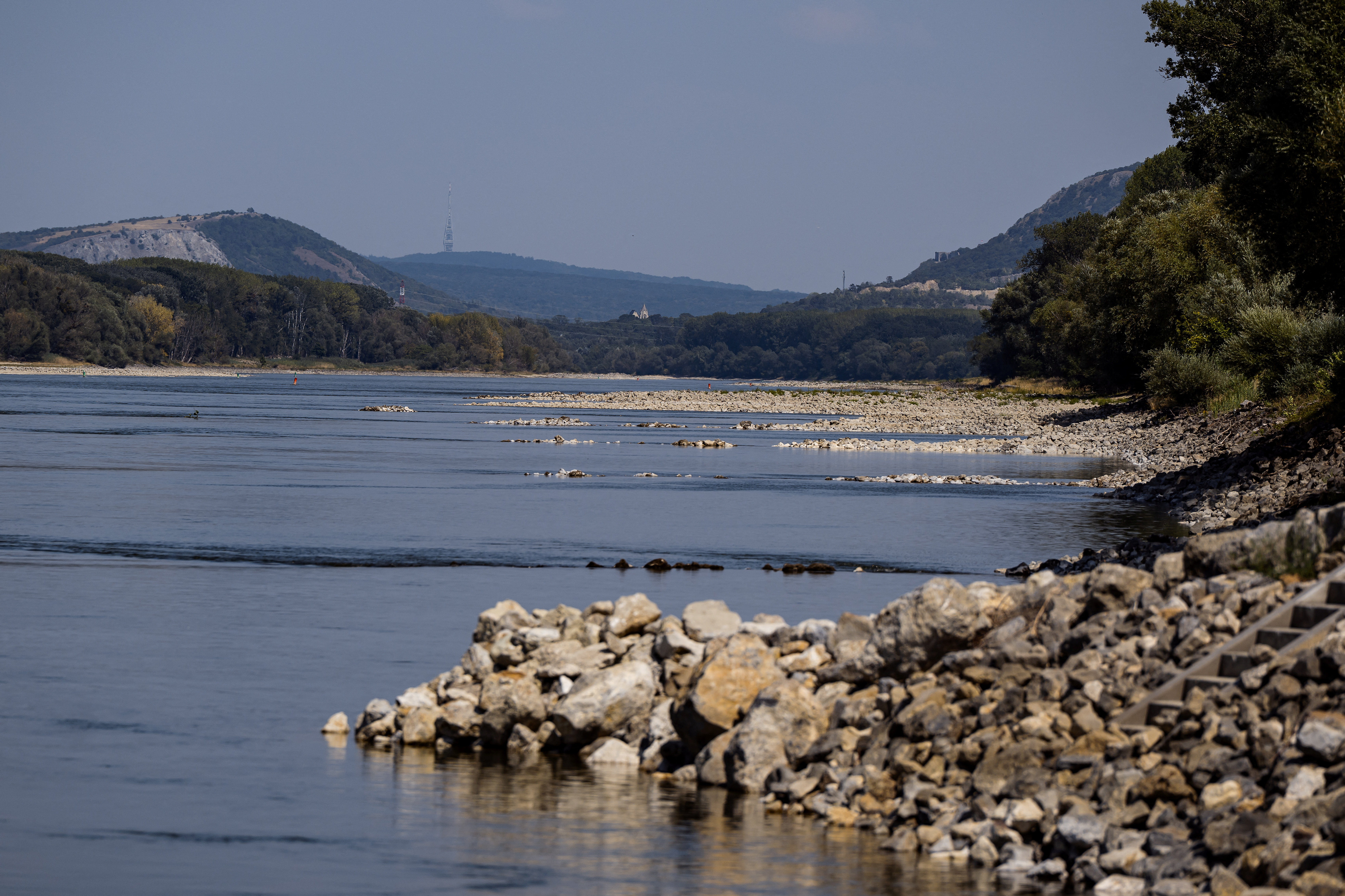 Sandbanks are exposed in the low water of the Danube River during a heatwave