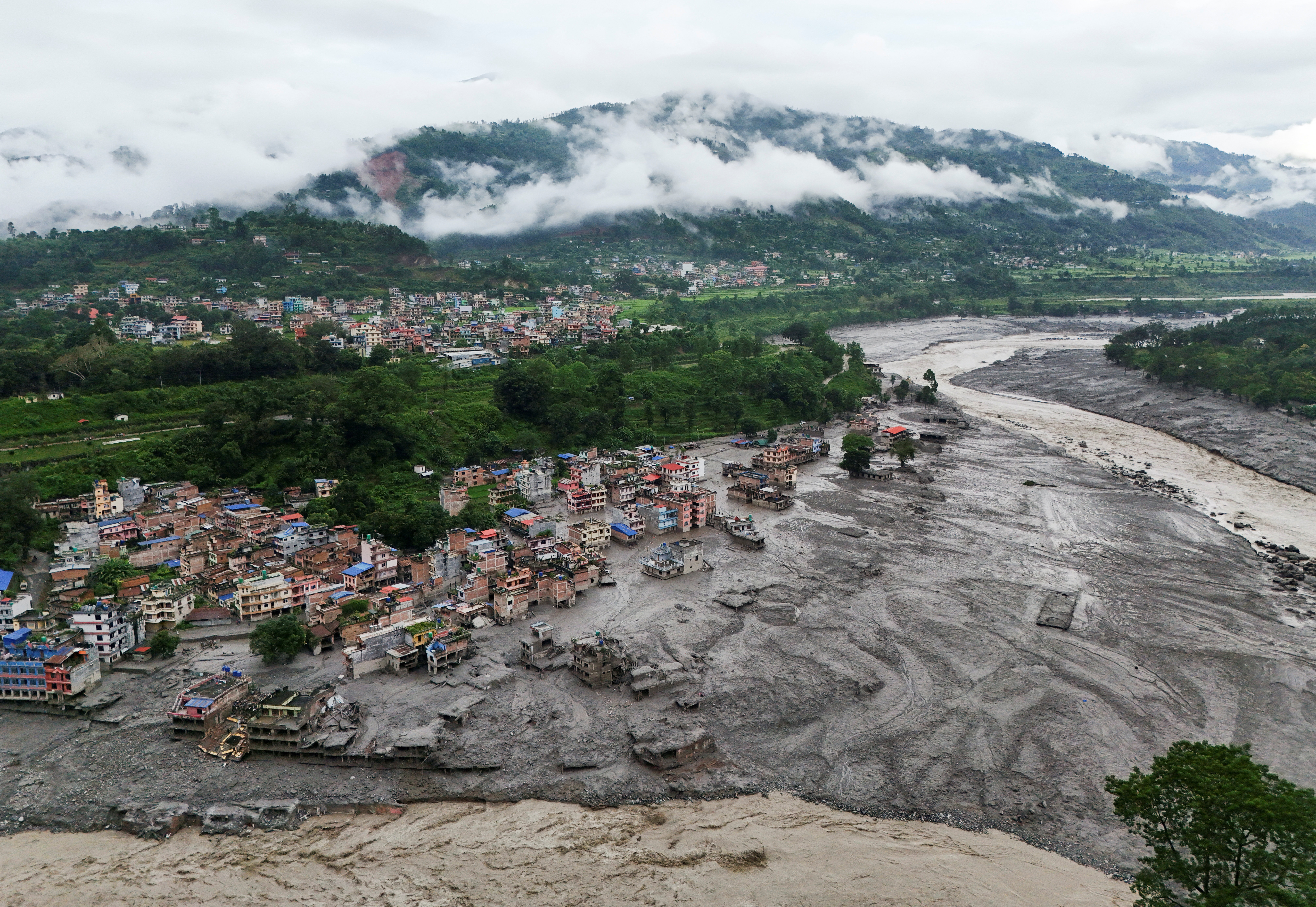 A drone view shows mud covering properties following a flash flood in Trishuli, Nuwakot district, Nepal, August 27, 2026. REUTERS/Navesh Chitrakar