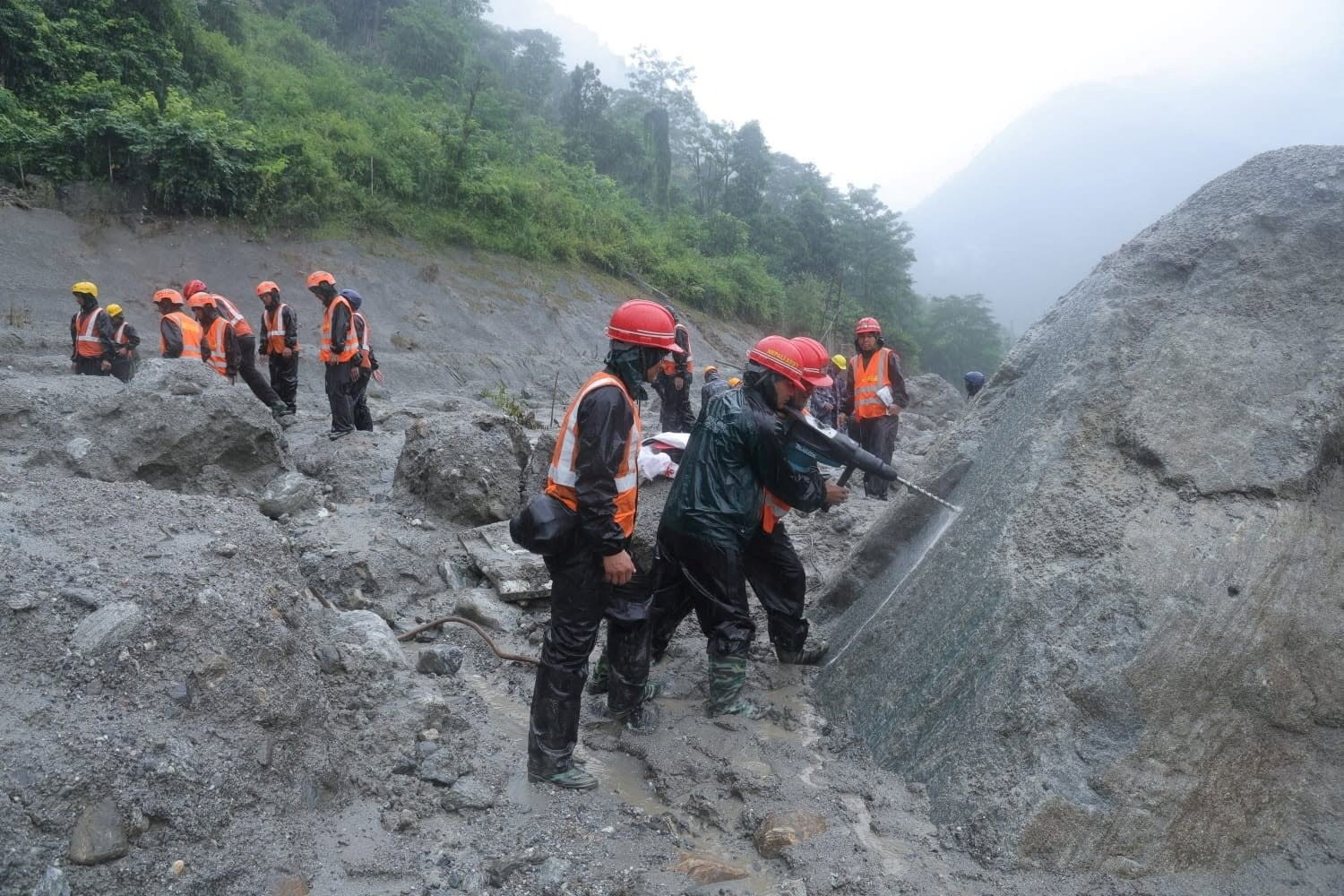 An undated handout photo of rescue workers taking part in a rescue operation near the tunnel of the Trishuli 3A Hydropower Project, following deadly flash floods and mudslides, in Rasuwa, Nepal