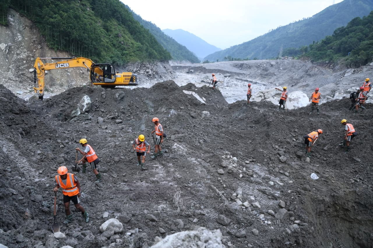 An undated handout photo of rescue workers taking part in a rescue operation near the tunnel of the Trishuli 3A Hydropower Project, following deadly flash floods and mudslides