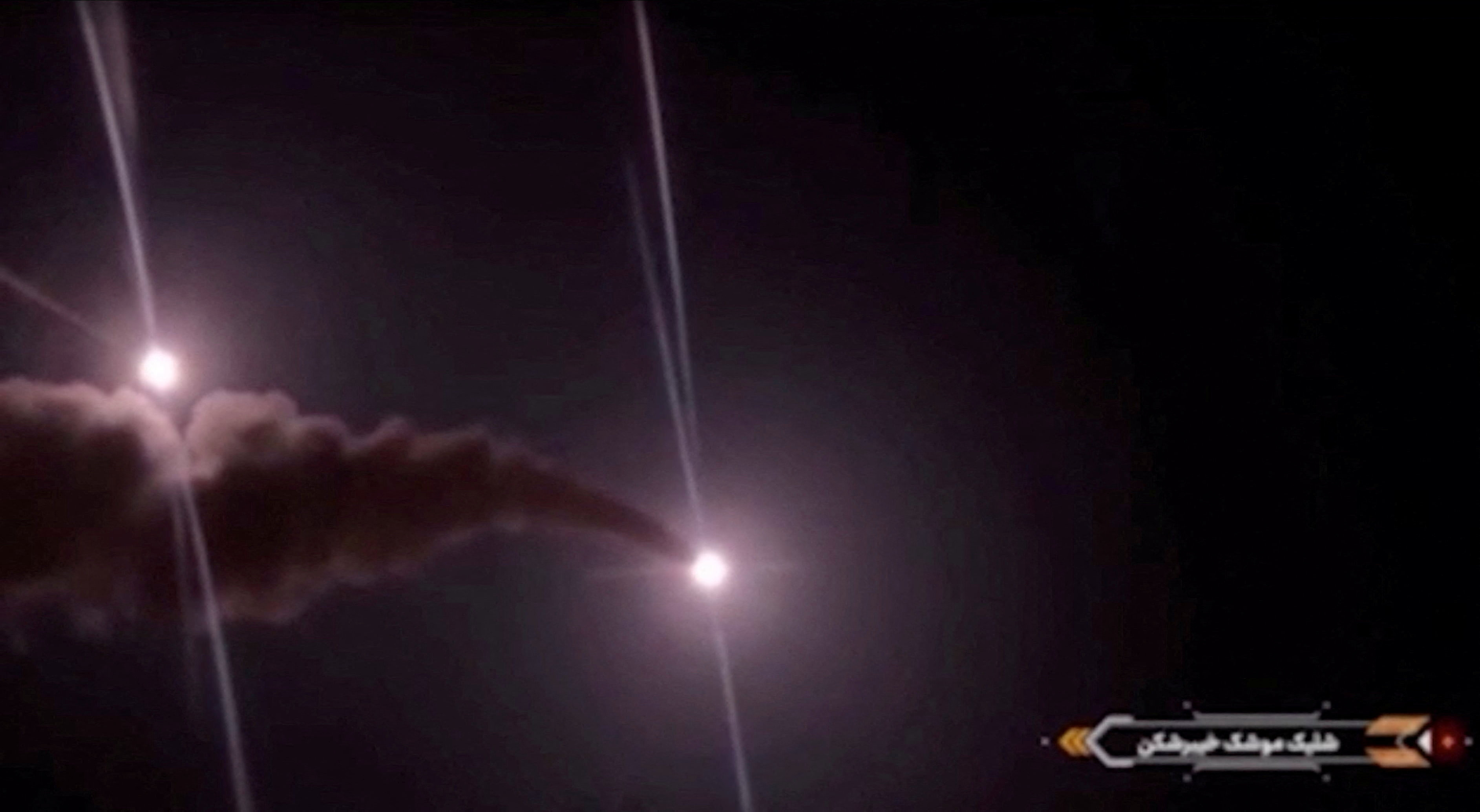 Projectiles streak across the sky