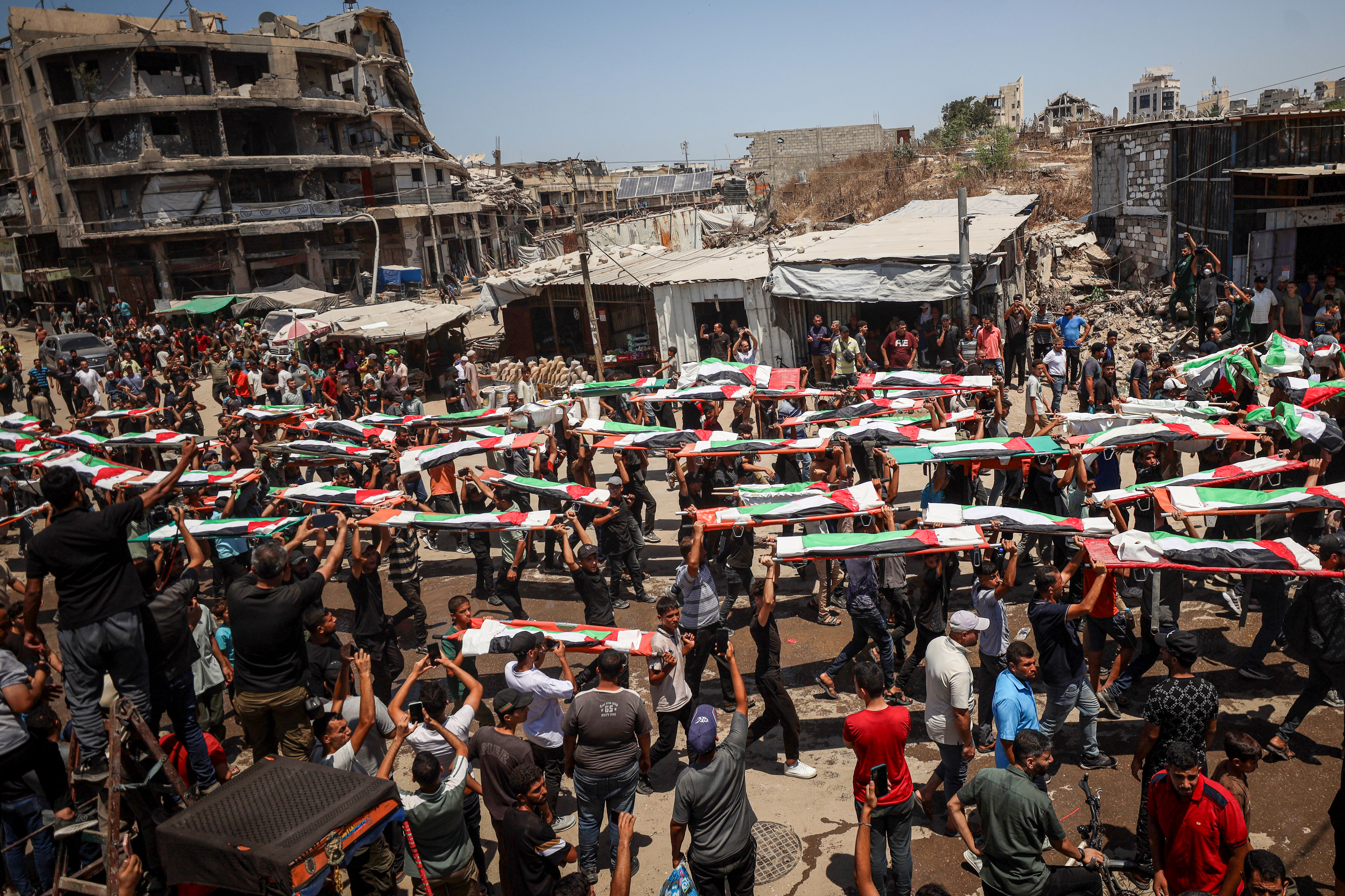 Mourners attend the funeral of the Abu Sharia and al-Hasayna families