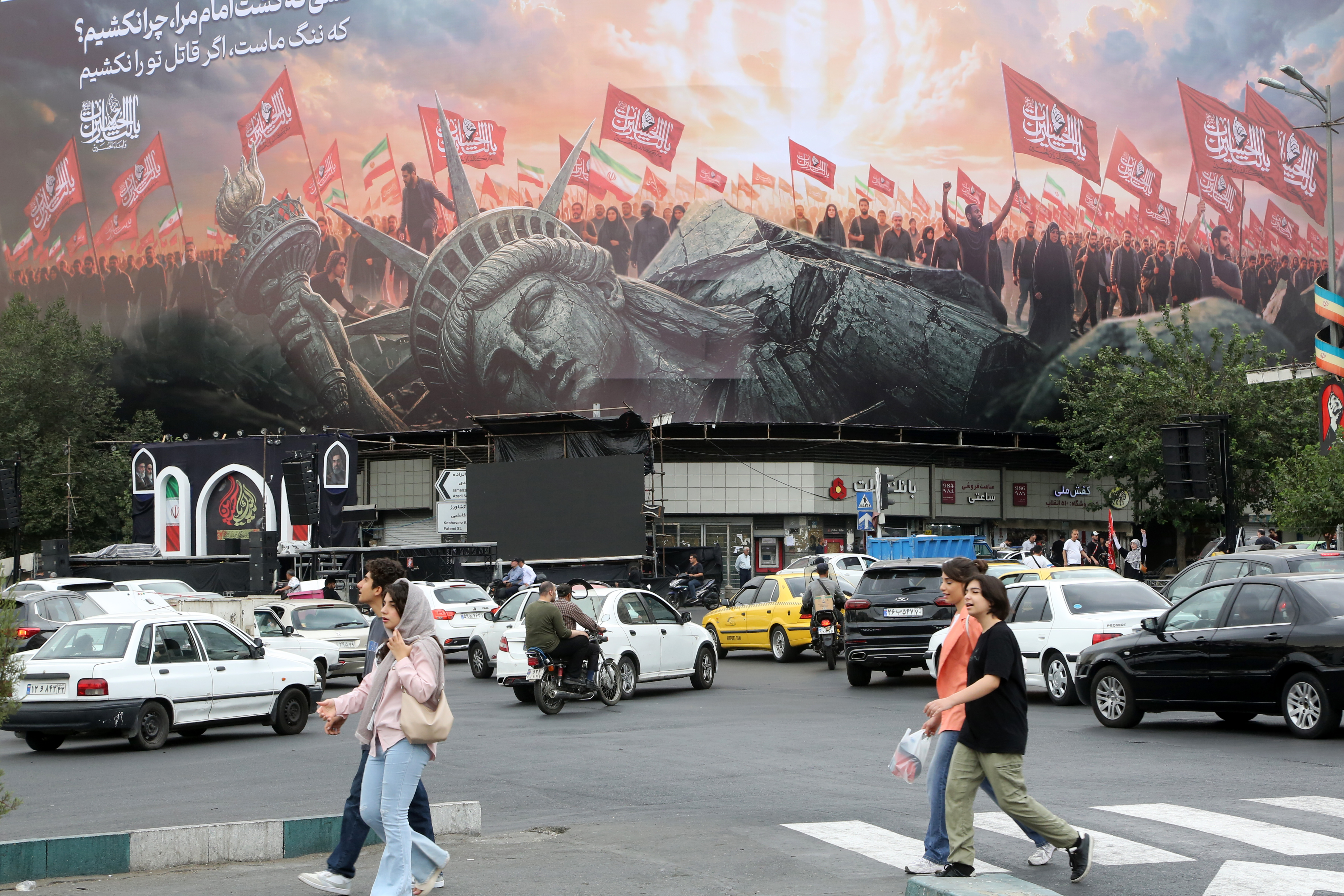 TEHRAN, IRAN - AUGUST 03: ("RESTRICTIONS: NO Access Israel Media/Persian Language TV Stations Outside Iran/Strictly No Access BBC Persian/VOA Persian/Manoto TV/Iran International TV") A giant anti-U.S. billboard is displayed at Enghelab (Revolution) Square in Tehran, Iran on August 03, 2026. ( Fatemeh Bahrami - Anadolu Agency )