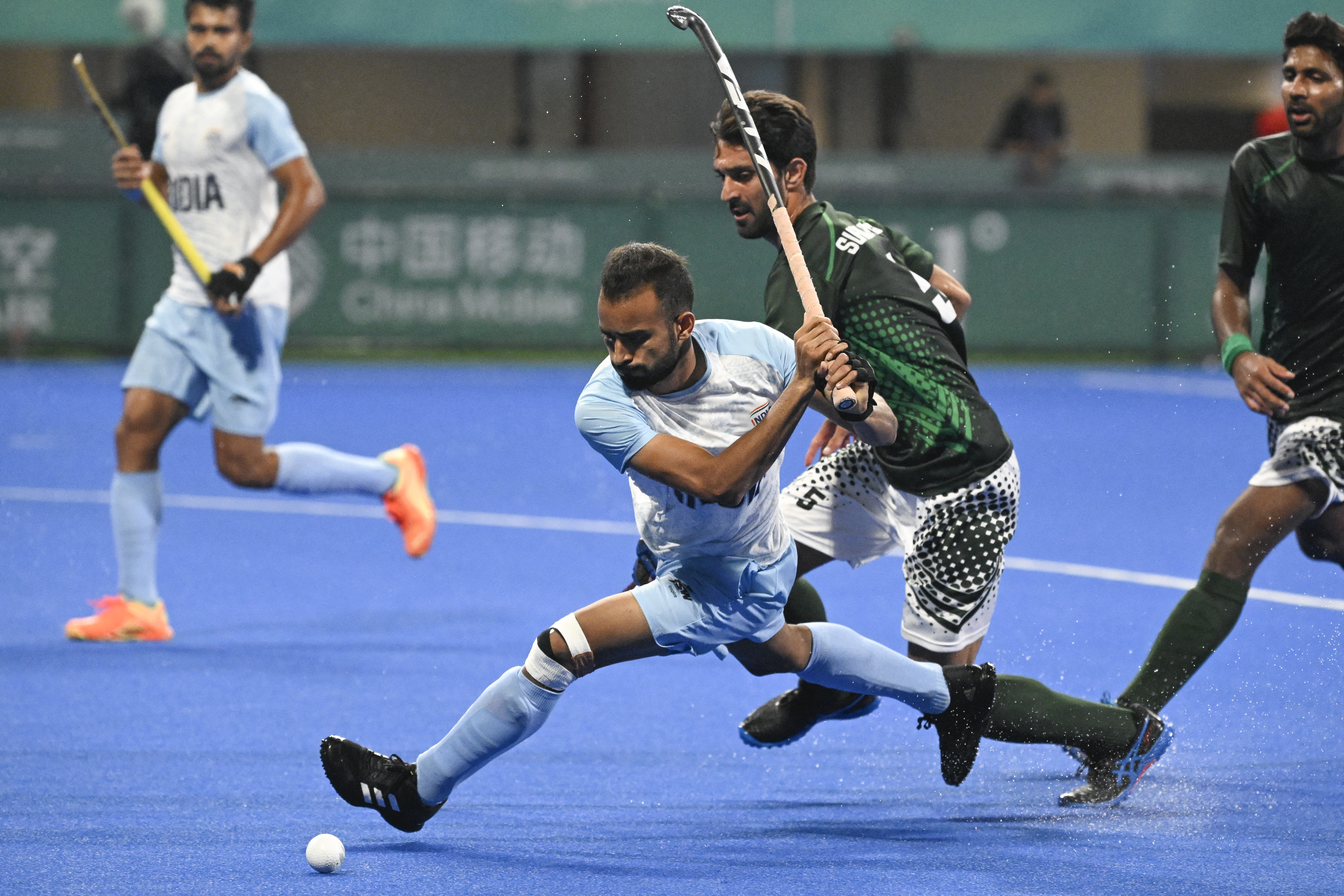 India's Lalit Kumar Upadhyay (2L) competes for the ball during the preliminary men's pool hockey match between India and Pakistan at the 2022 Asian Games in Hangzhou in China's eastern Zhejiang province on September 30, 2023. (Photo by WANG Zhao / AFP)