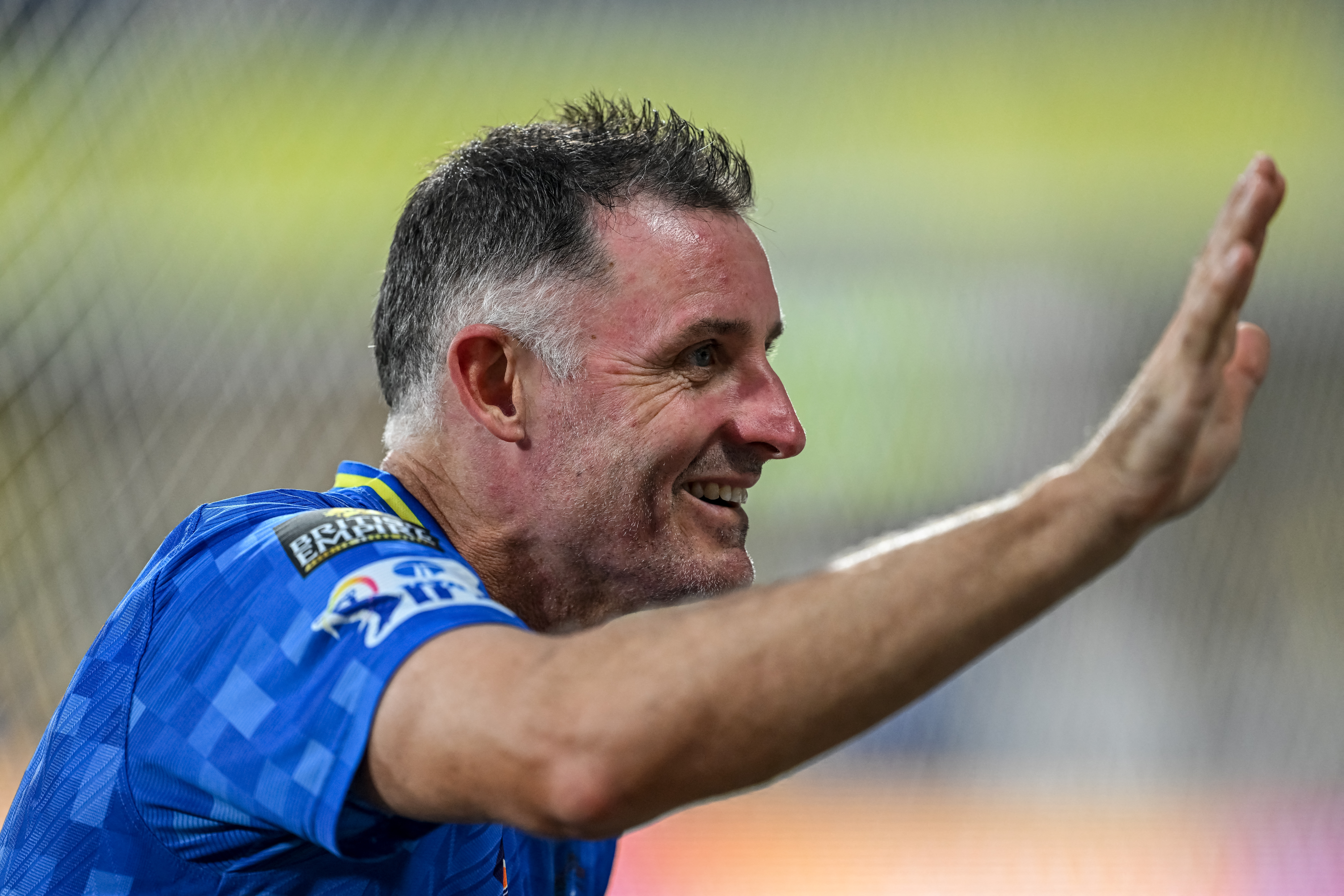 Chennai Super Kings' batting coach Michael Hussey gestures and smiles.