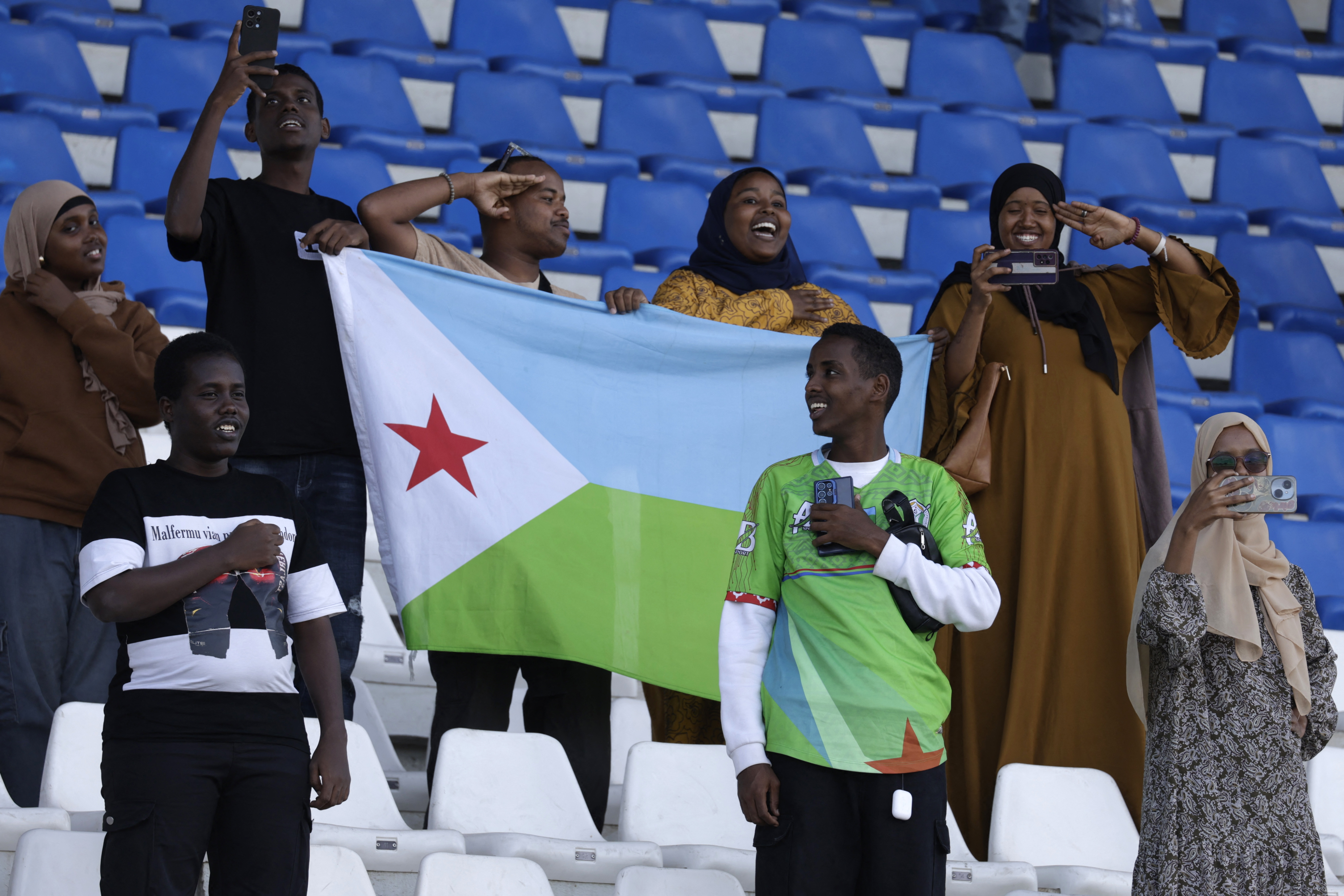 Djibouti fans cheer during the FIFA World Cup 2026 Africa qualifier football match between Djibouti and Egypt at the Larbi Zaouli Stadium in Casablanca on October 8, 2025. (Photo by Abdel Majid BZIOUAT / AFP)