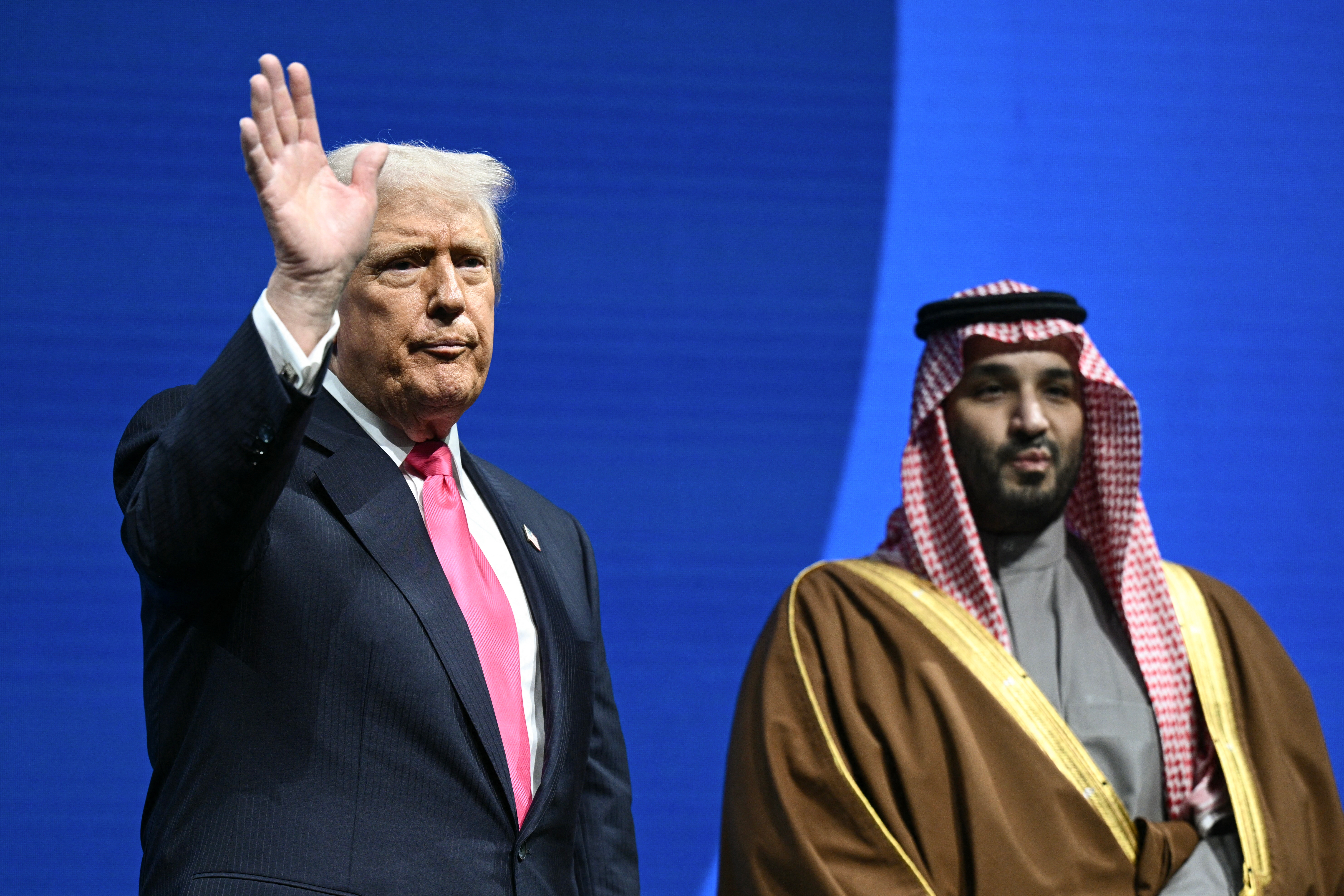 Crown Prince and Prime Minister of the Kingdom of Saudi Arabia Mohammed bin Salman and US President Donald Trump wave as they depart the US-Saudi Investment Forum at the John F. Kennedy Center for the Performing Arts in Washington, DC on November 19, 2025. (Photo by Brendan SMIALOWSKI / AFP)