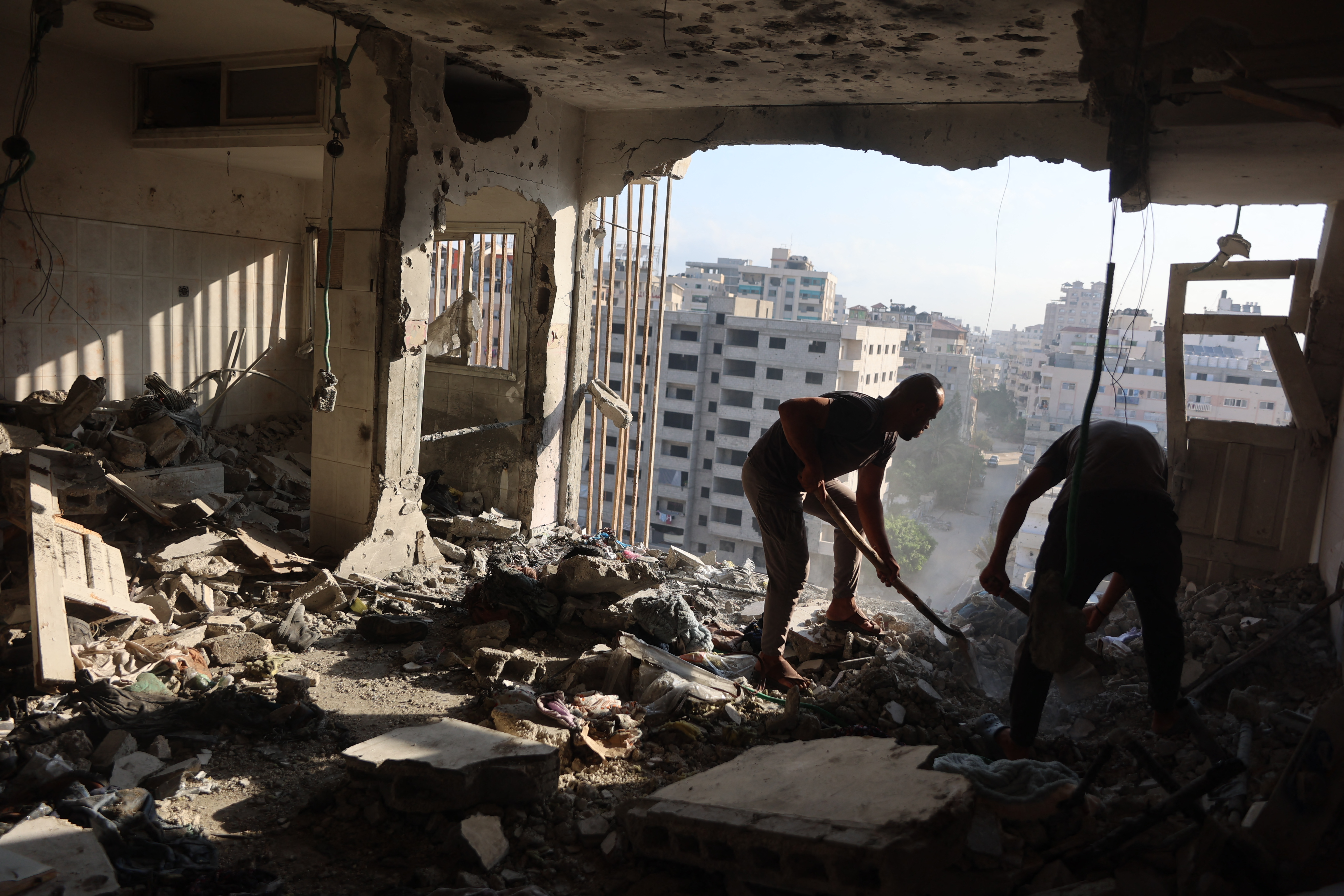Palestinian residential salvage what they can from an apartment targeted in overnight Israeli airstrikes in Gaza City on August 2, 2026.