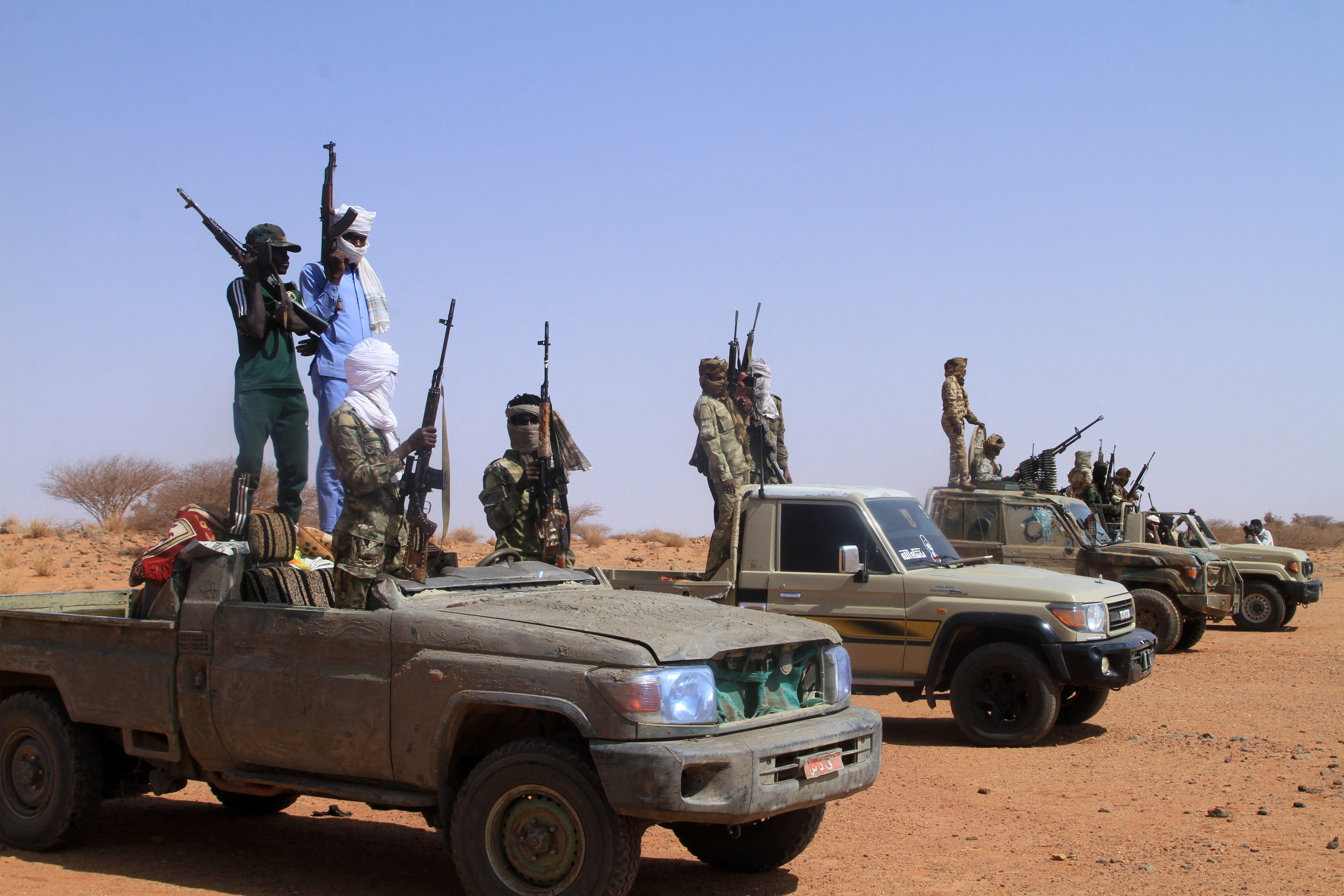 Armed defectors from Sudan’s paramilitary Rapid Support Forces arrive in vehicles as they surrender to the Sudanese army in western Omdurman