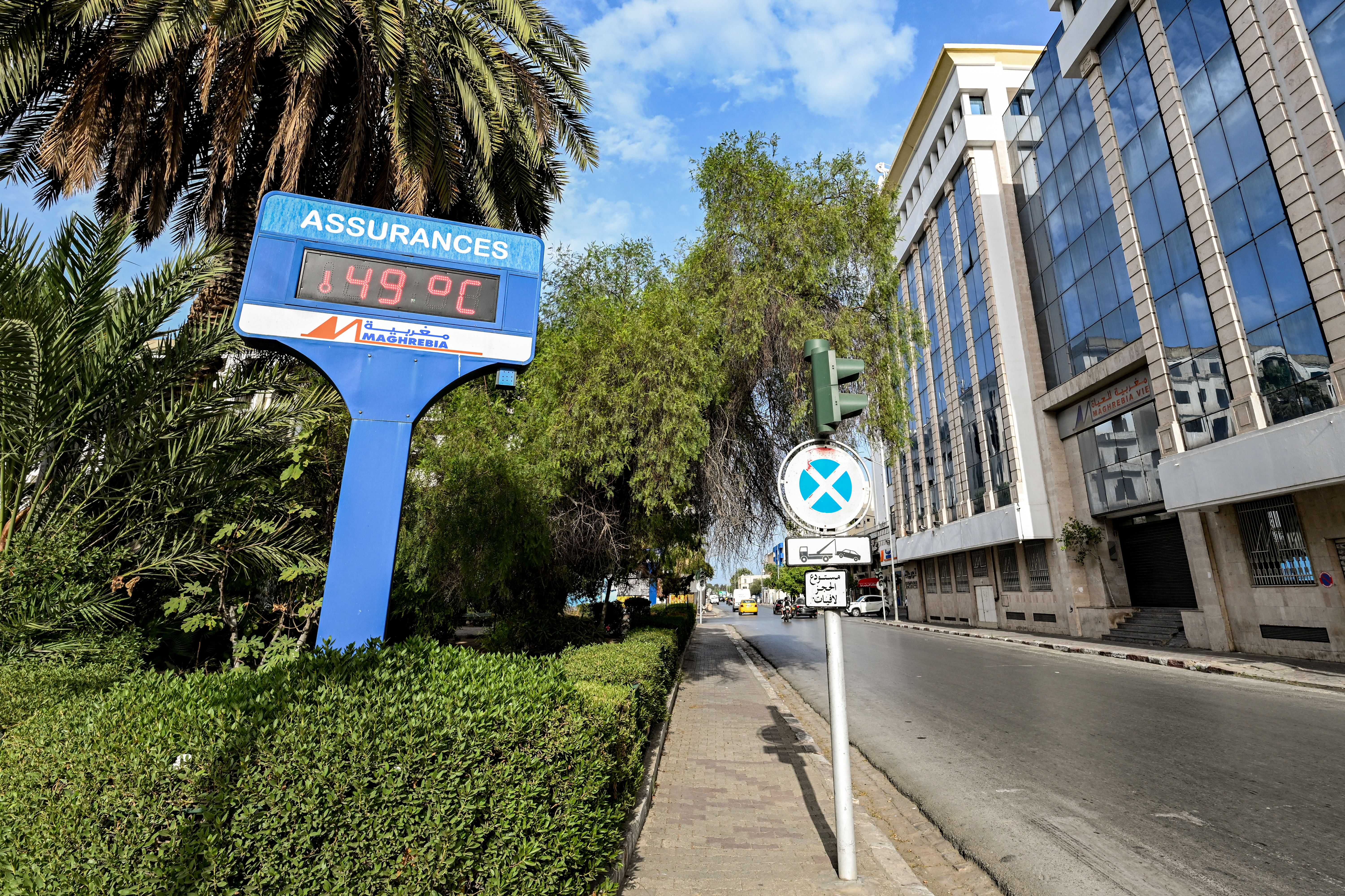 A sign displaying an ambient temperature of 49°C is pictured along a street in Tunis on August 24, 2026, as Tunisia faced a heatwave with temperatures exceeding 48°C amid daily water and electricity cuts [Fethi Belaid/AFP]