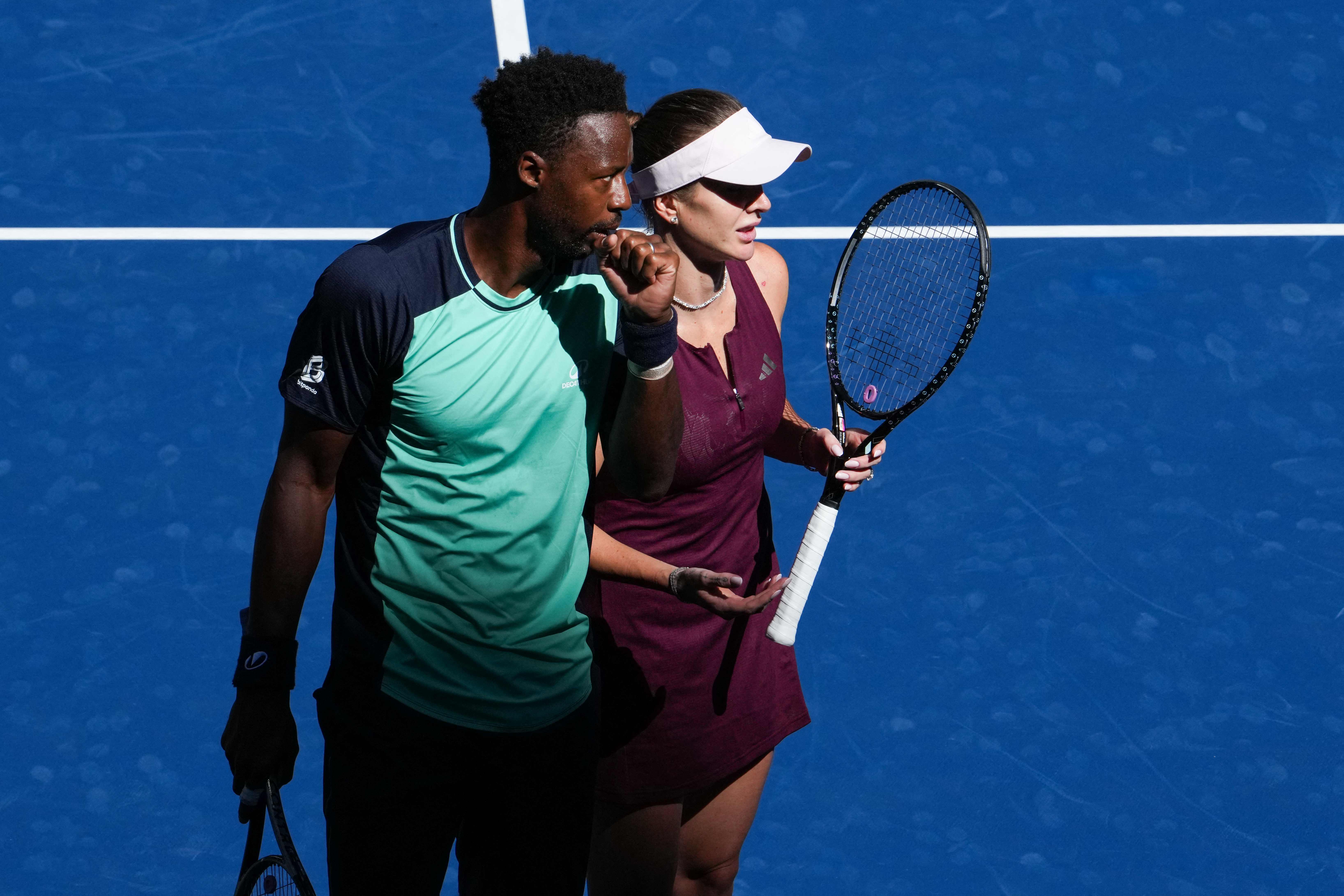 (L/R) France's Gael Monfils and Ukraine's Elina Svitolina look on during their mixed doubles tennis match against Canada's Felix Auger-Aliassime and Philippines' Alexandra Eala during Fan Week as part of the 2026 US Open tennis tournament at the USTA Billie Jean King National Tennis Center in New York, on August 25, 2026. (Photo by TIMOTHY A. CLARY / AFP)