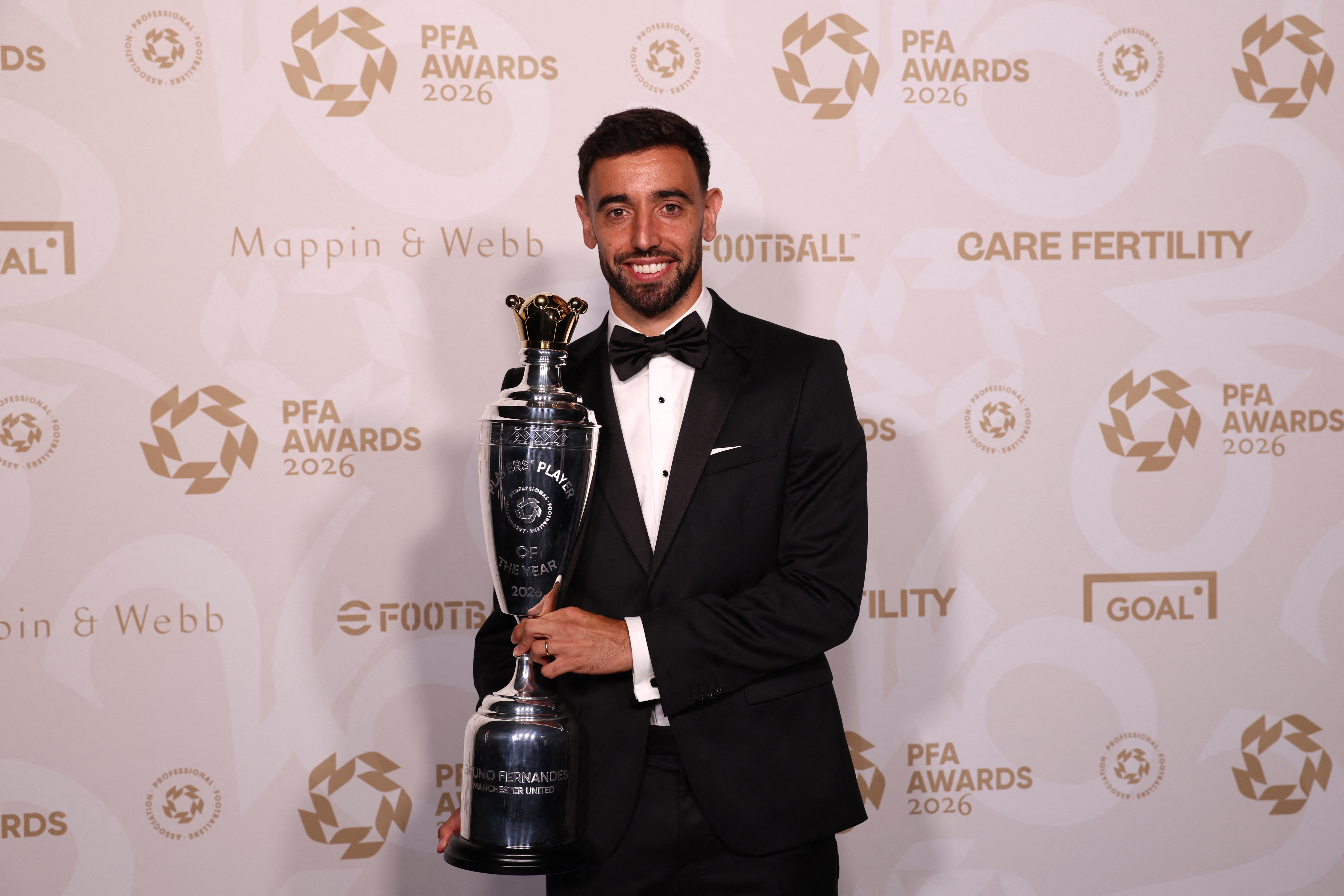 Manchester United's Portuguese player Bruno Fernandes poses with the Men's PFA Players' Player of the Year award.