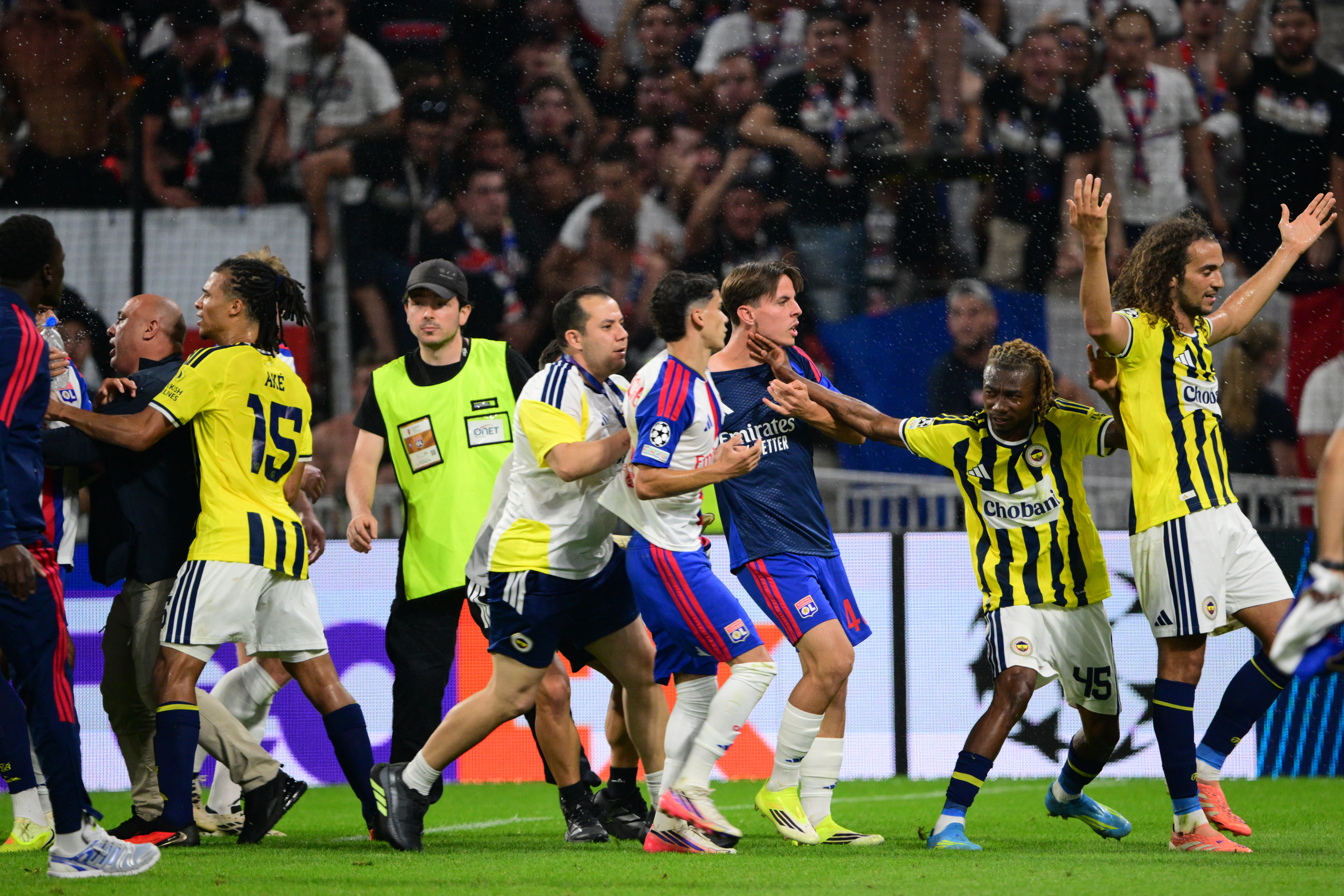 Fenerbahce's Malian forward #45 Nene Dorgeles (2R) tries to seperate Fenerbahce's French midfielder #06 Matteo Guendouzi (R) and Lyon's players.