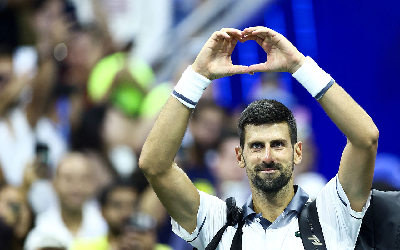 Serbia's Novak Djokovic makes a shape with his hands after losing the match against Argentina's Mariano Navone during the men's singles first round tennis match on day one of the US Open tennis tournament at the USTA Billie Jean King National Tennis Center in New York City on August 30, 2026. (Photo by CHARLY TRIBALLEAU / AFP)