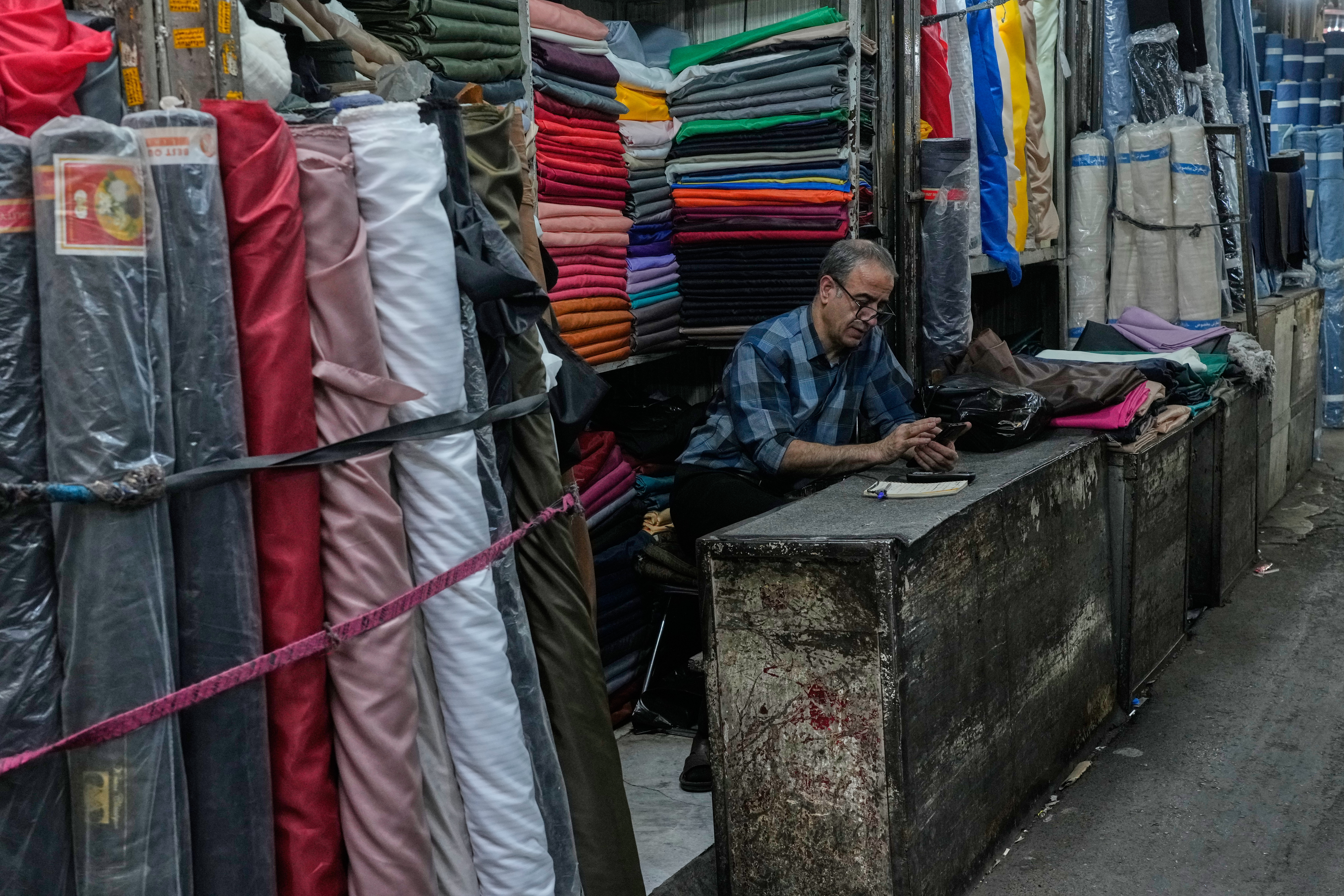 A shopkeeper mans his stall at the Grand Bazaar in Tehran