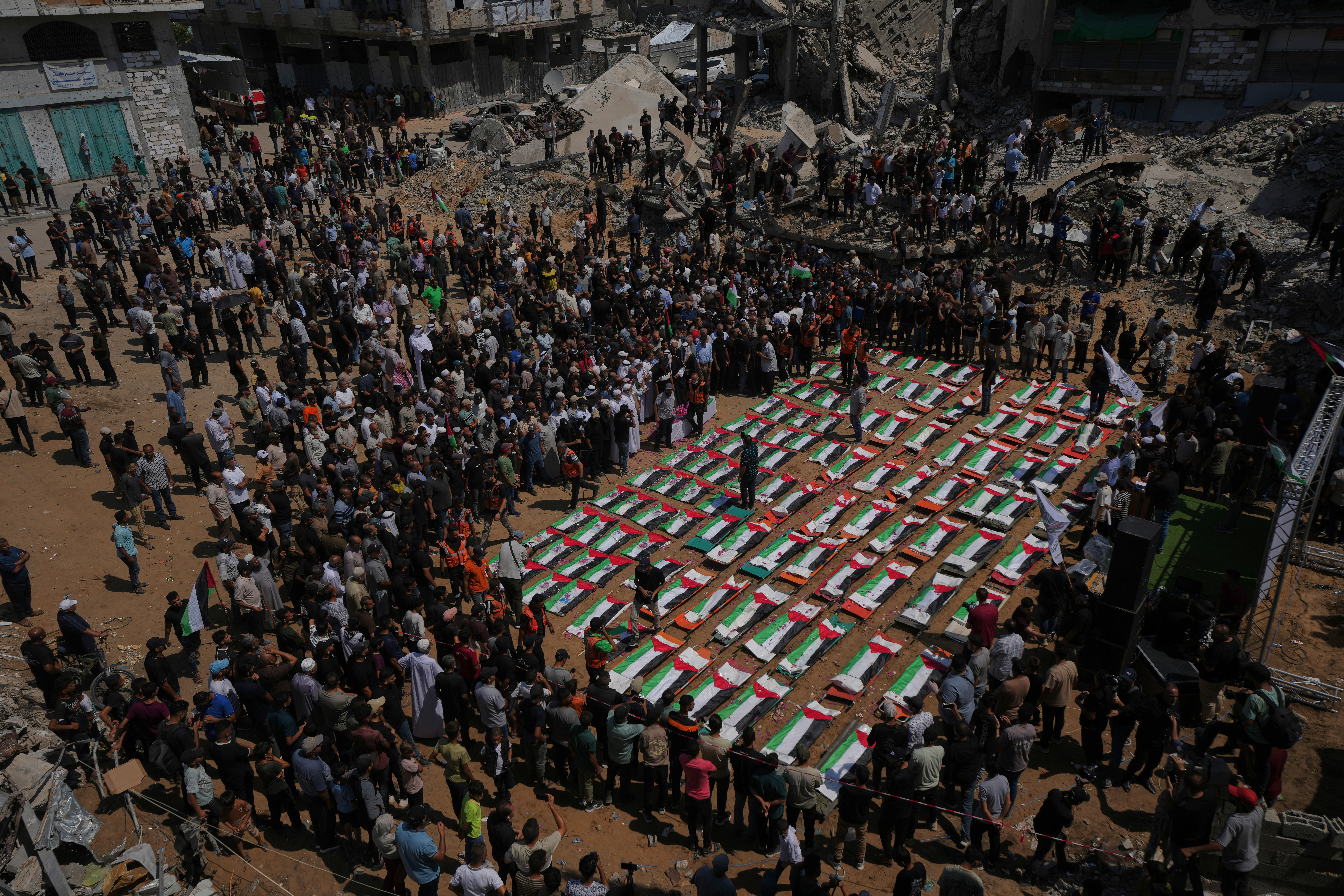 Bodies of members of the al-Hasayna and Abu Sharia families, killed in an Israeli strike in 2023 and recently recovered from the rubble, are draped in Palestinian flags during their funeral in Gaza City, on Tuesday, August 4, 2026