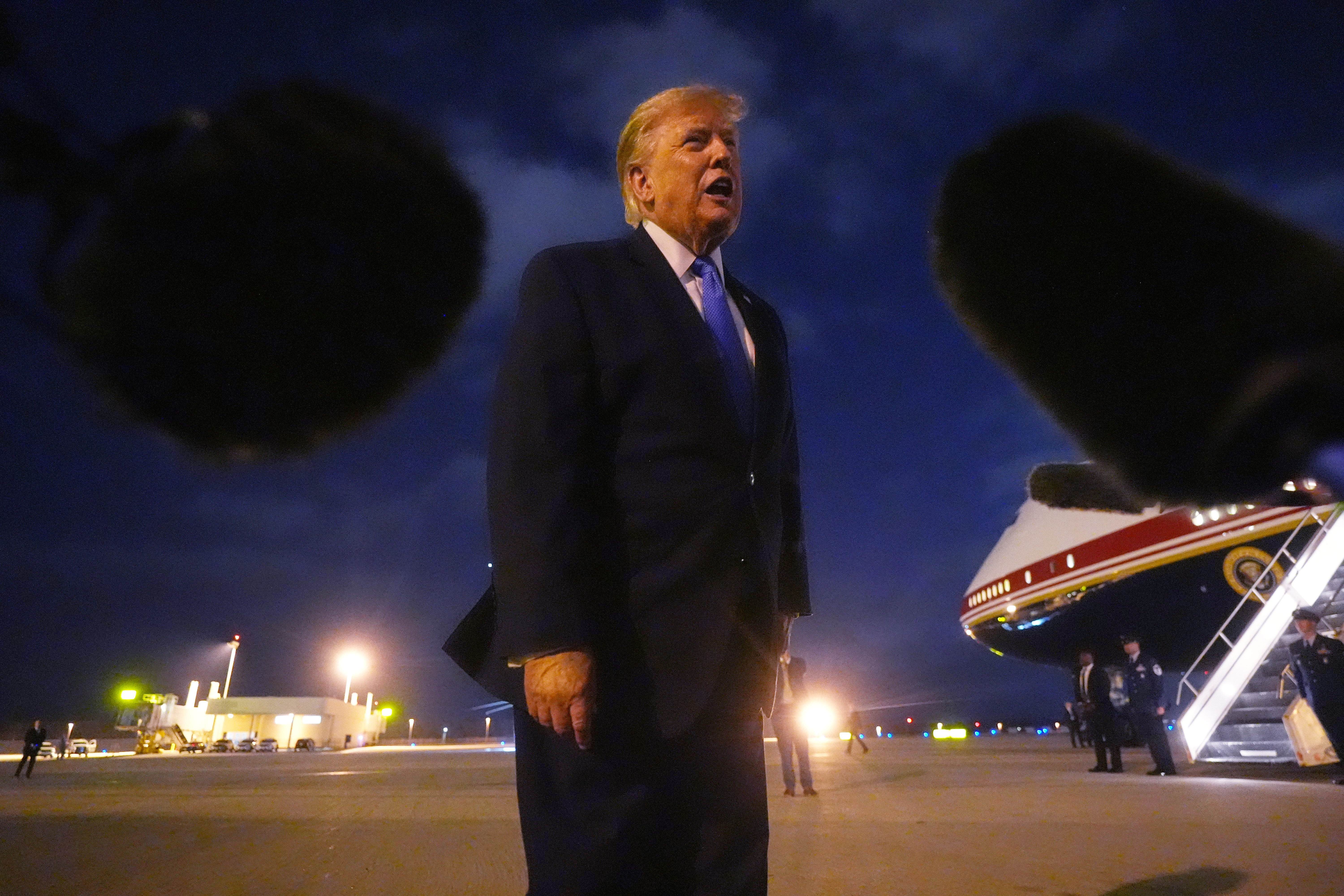 President Donald Trump talks to reporters before he boards Air Force One, Tuesday, Aug. 4, 2026, at Los Angeles International Airport in Los Angeles. (AP Photo/Mark Schiefelbein)