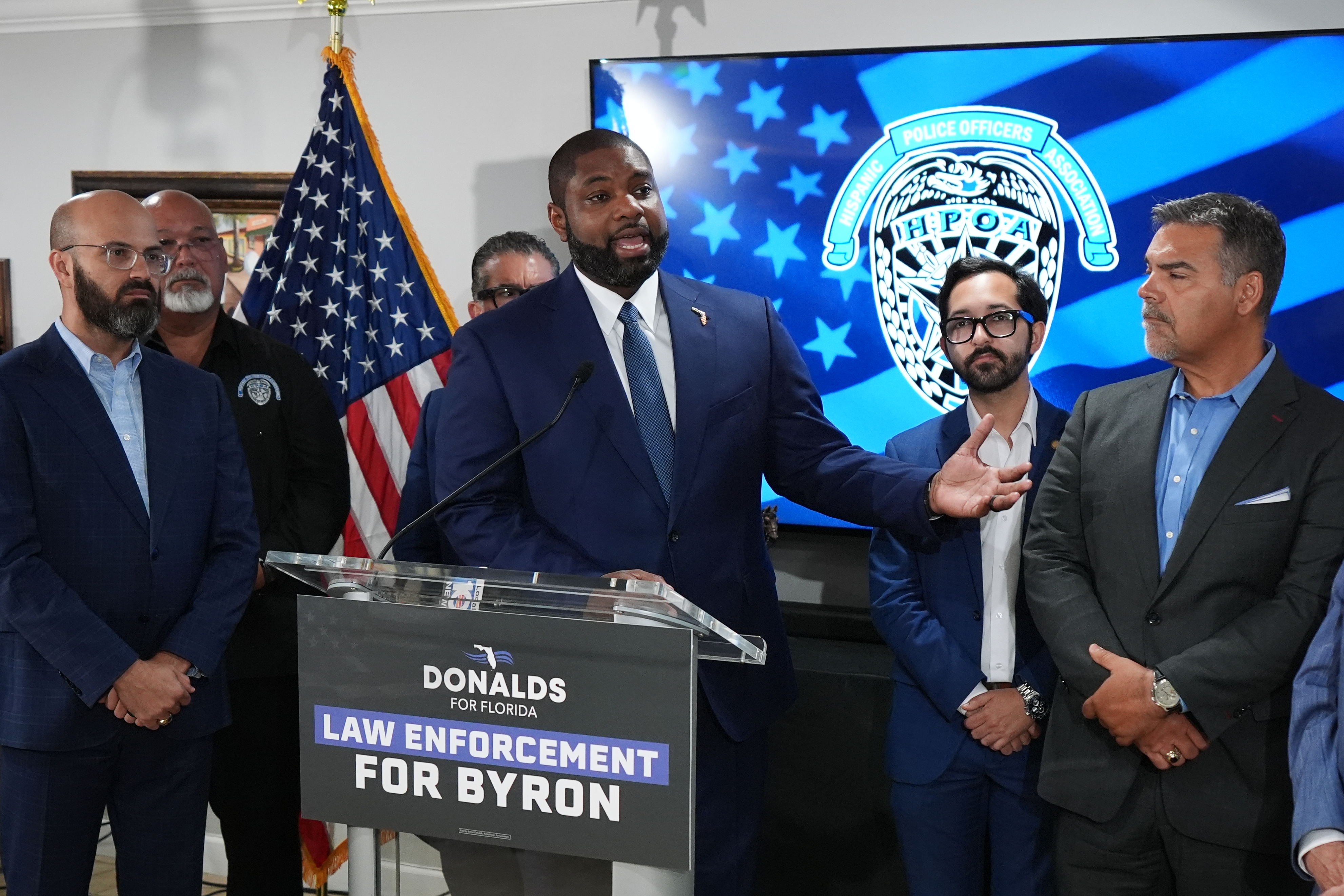 Florida Republican congressman and gubernatorial candidate Byron Donalds addresses members of the Hispanic Police Officers Association in Doral, Fla., after receiving the group's endorsement, Thursday, Aug. 6, 2026. Accompanying him are, from left, Florida state representative Tom Fabricio, HPOA President Carlos Arguelles, and state representatives Omar Blanco (obscured), Juan Carlos Porras, and Alex Rizo. (AP Photo/Rebecca Blackwell)