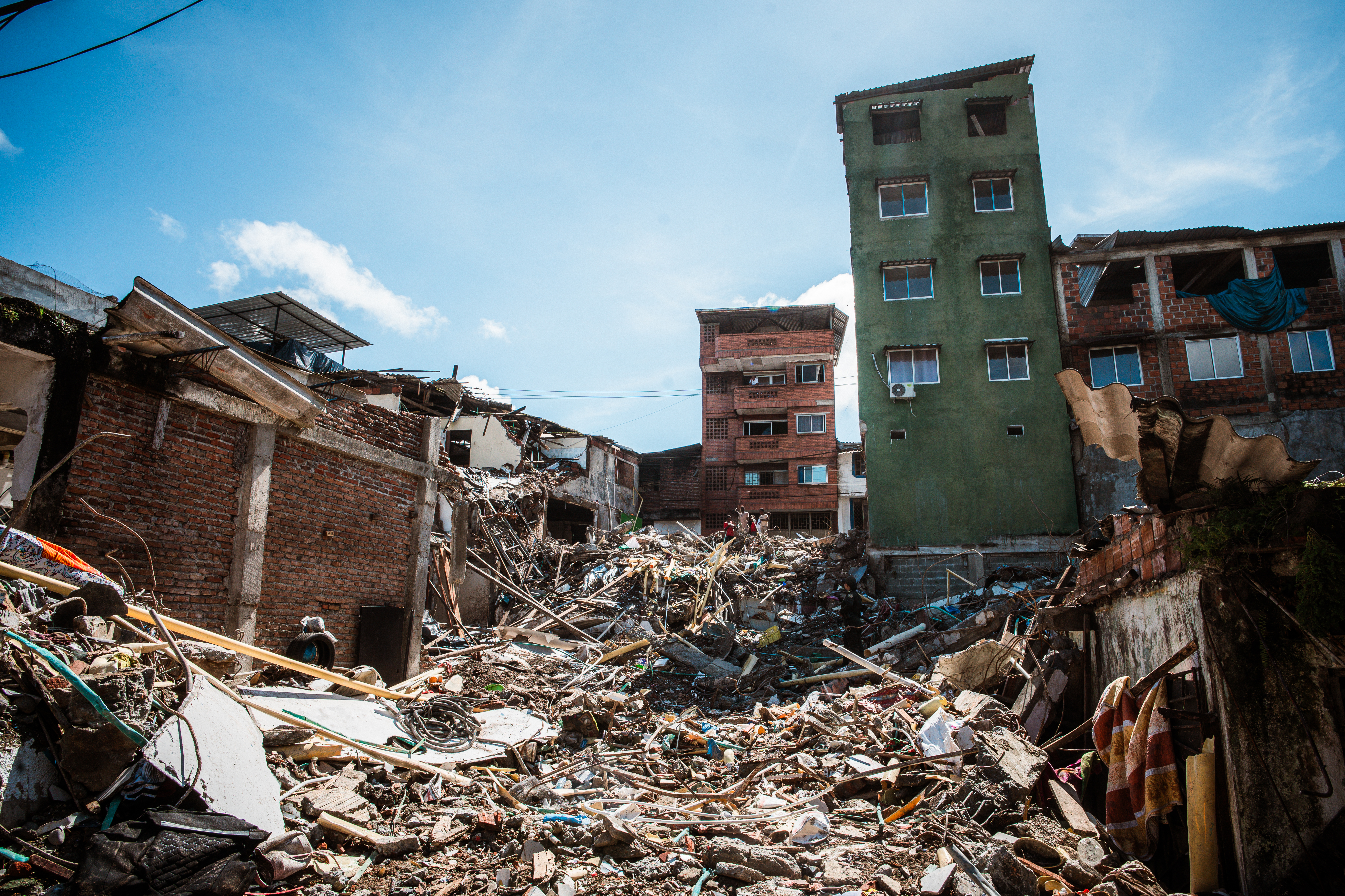 The remains of the five-story building that collapsed onto Lorena Hipis’s home during the August 10 earthquake. [Euan Wallace / Al Jazeera]