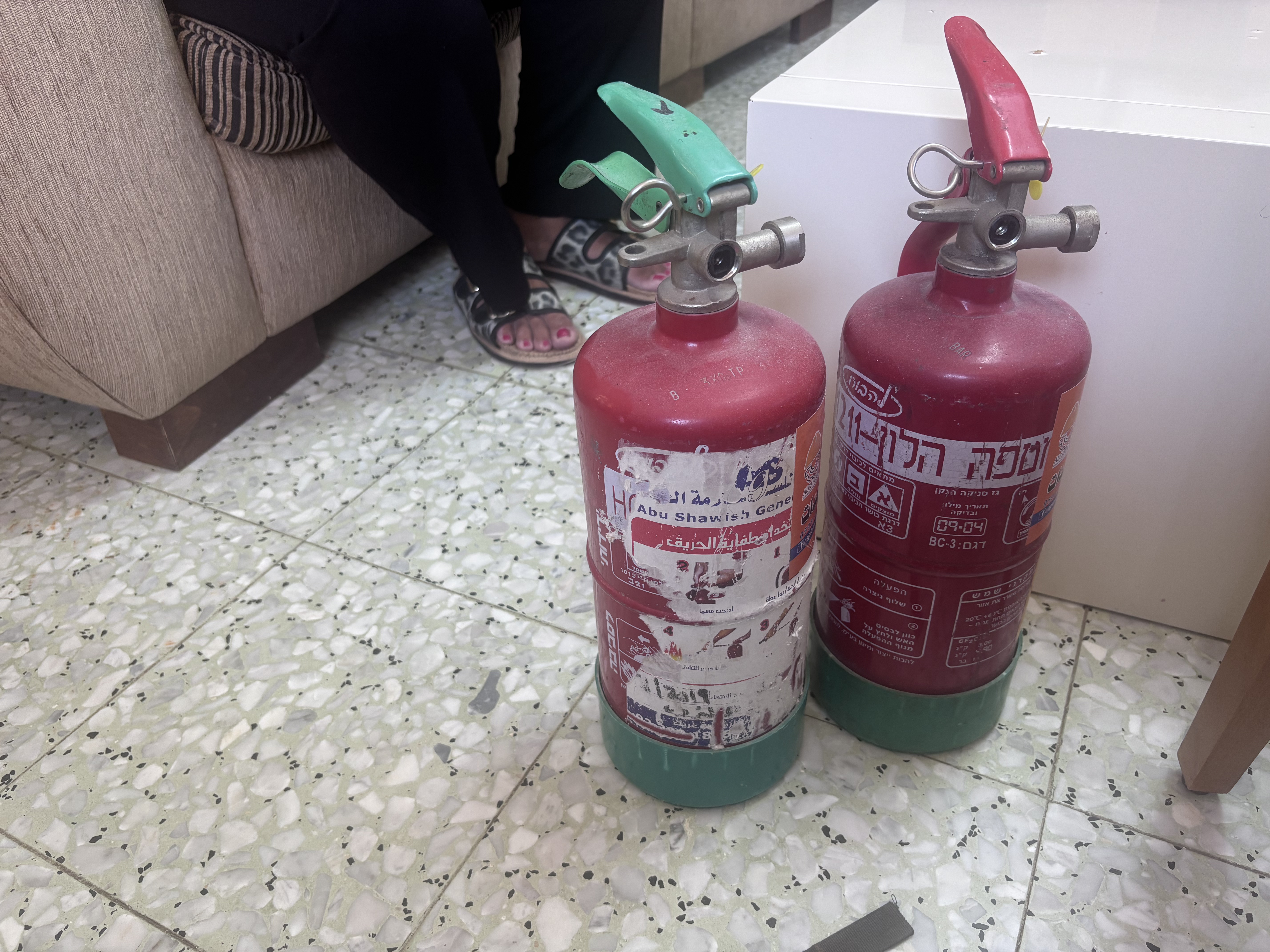 Fire extinguishers that Sandra and Roland bought to extinguish fires they say are lit by Israeli settlers [Al Jazeera]