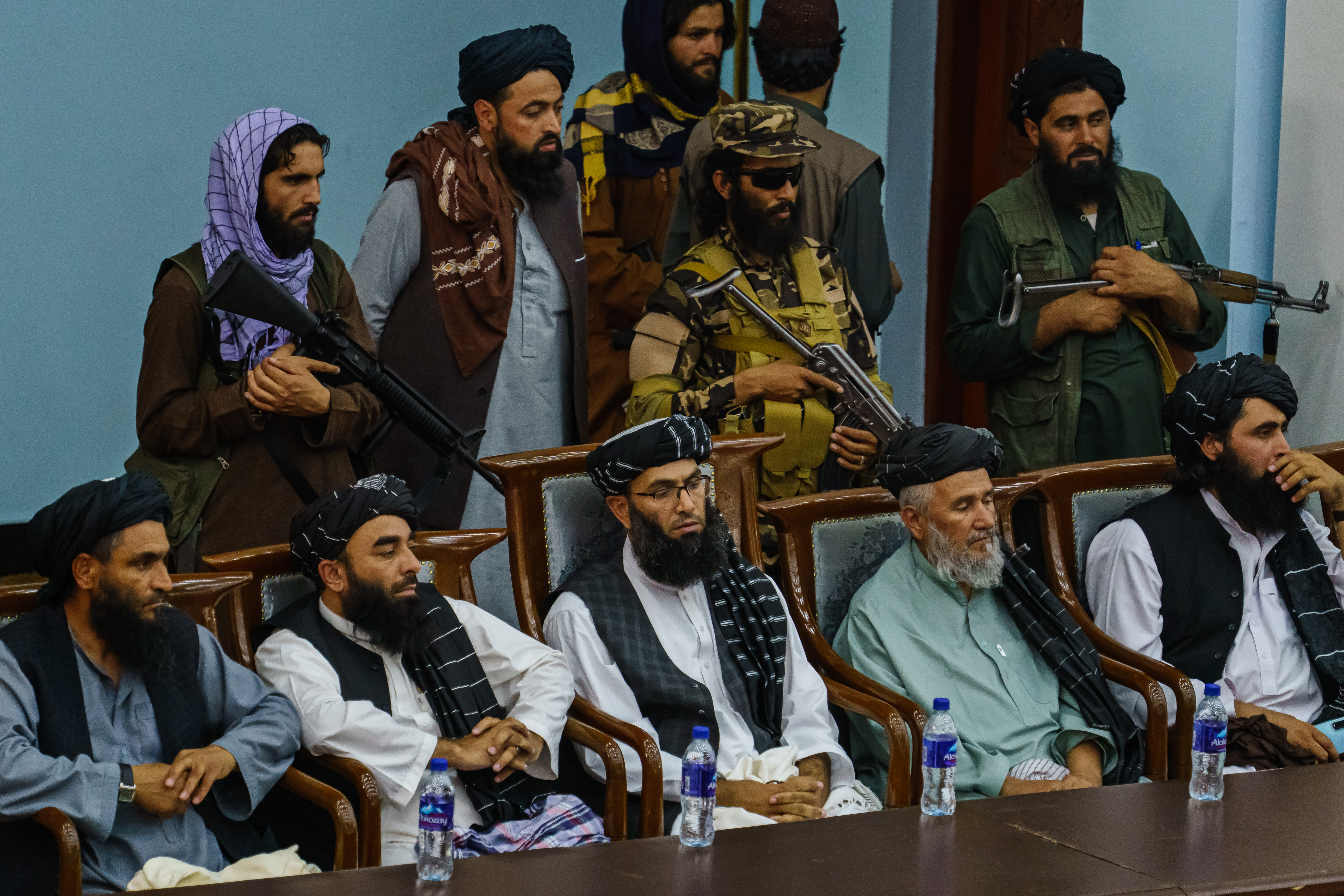 KABUL, AFGHANISTAN -- AUGUST 23, 2021: Zabihullah Mujahid, second from bottom left, joins others as hundreds of religious leaders attend the Taliban's preaching and guidance commission at the Loya Jirga, in Kabul, Afghanistan, Monday, Aug. 23, 2021. (MARCUS YAM / LOS ANGELES TIMES)